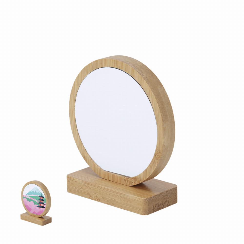 A round mirror with a bamboo frame and base, accompanied by a smaller decorative piece with a colourful design. Farnes - Image 1