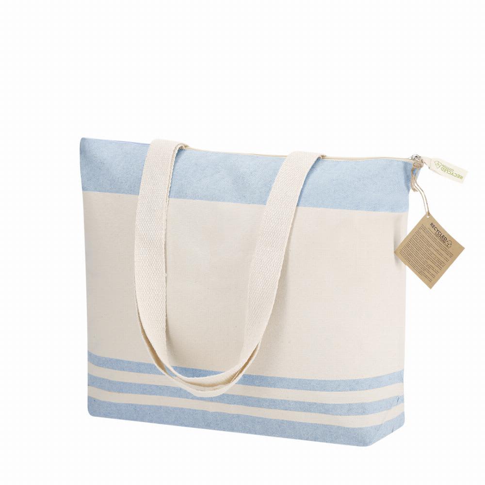 A tote bag featuring a light blue and cream design with a zip closure and long straps for carrying. Tanor - Image 1