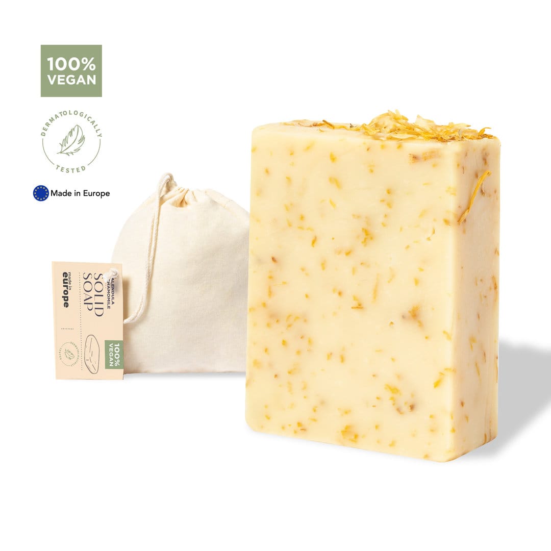A bar of vegan soap with yellow and white tones, alongside a small fabric bag. It has a natural, textured appearance. Gopax - Image 1