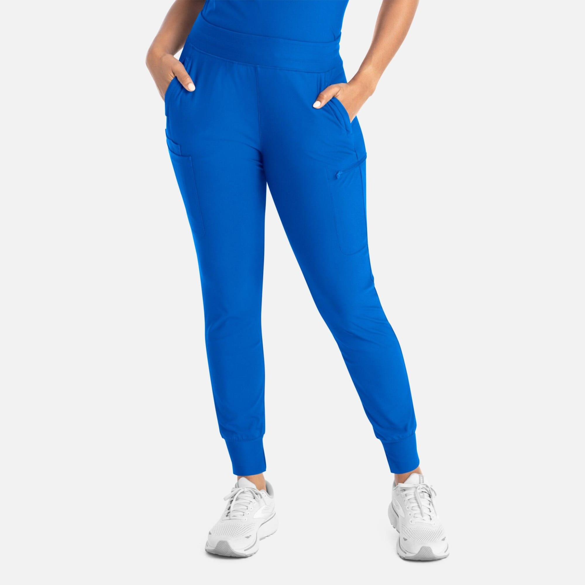 Bright blue mid-rise joggers with pockets, styled with a fitted top and white sneakers. Embrace Mia Tapered Leg Pant - Image 1