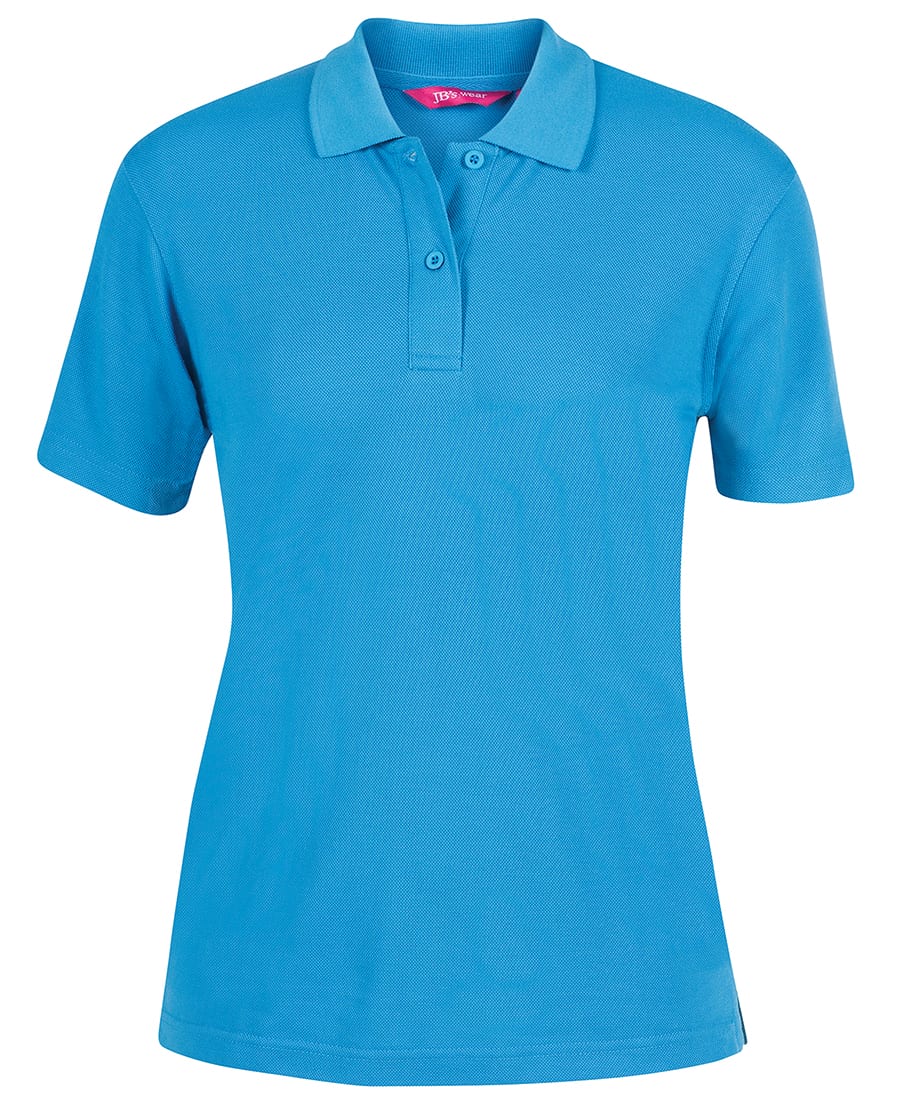 A blue ladies' polo shirt with a collar and buttons, featuring a logo on the front. JB's Ladies 210 Polo - Image 1