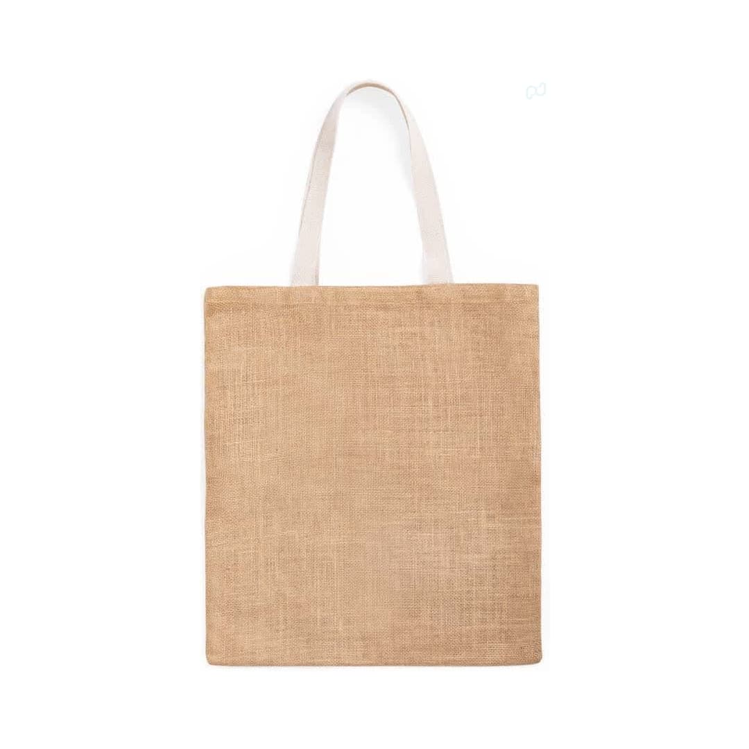A natural jute tote bag with light-coloured handles and a plain design. The bag has a minimalistic aesthetic. Dhar Bag - Image 1