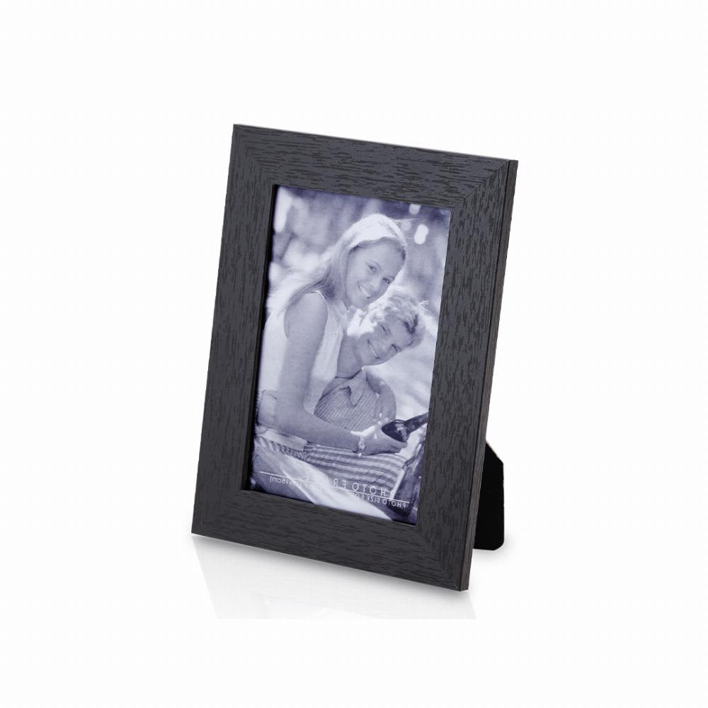 A black photo frame showcasing a black-and-white image of a couple, standing upright with a back support. Stan - Image 1