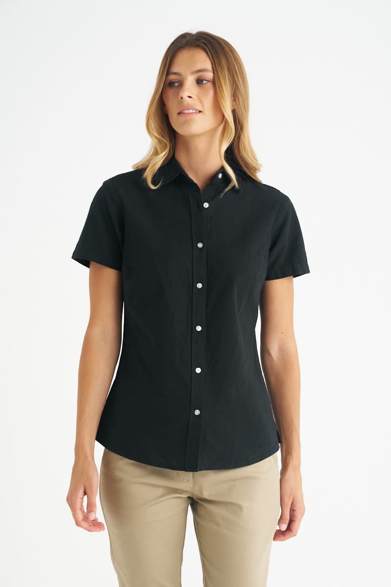 A black ladies short sleeve shirt with a collared neckline and button front, featuring a logo. Floyd - Ladies Short Sleeve Shirt - Image 1