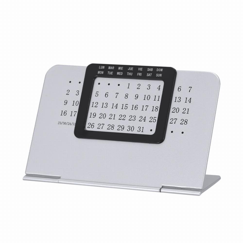 A desktop calendar with a silver base and a black date grid. Displays days of the week and numbers for the month. Lider - Image 1