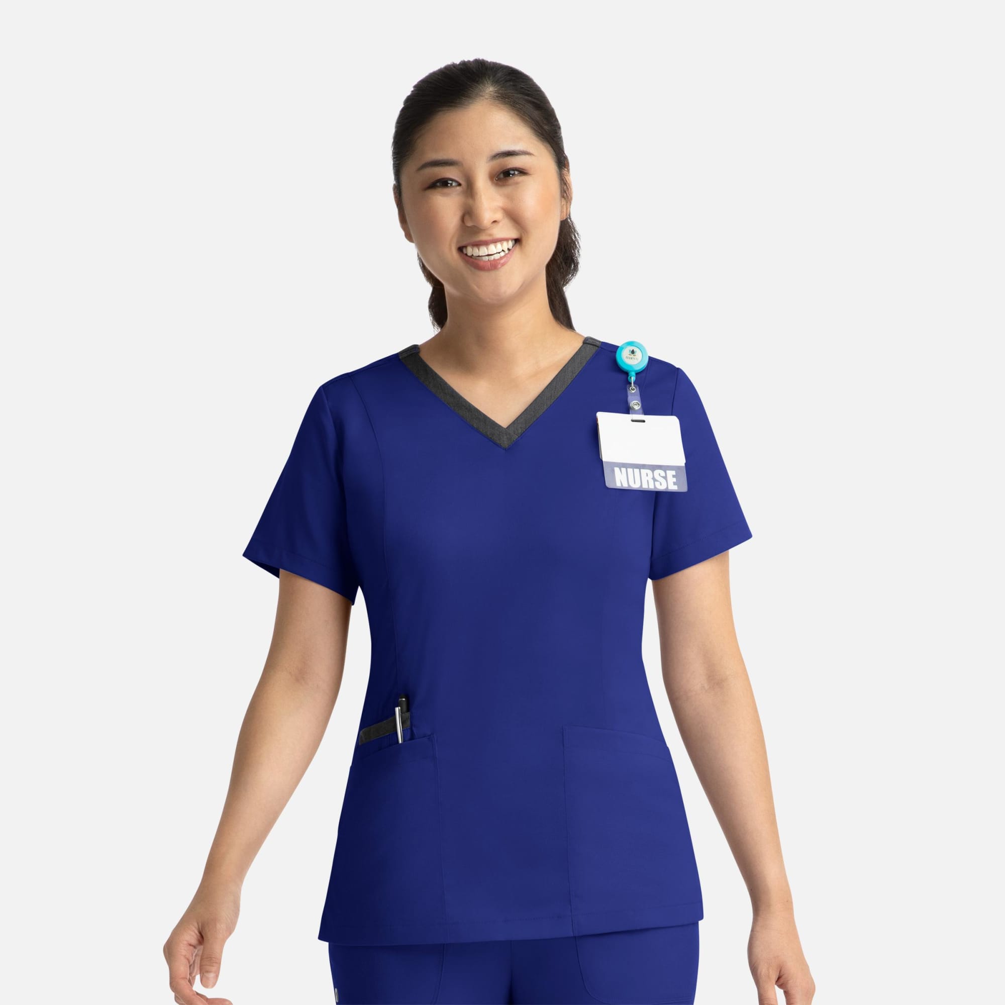 A woman's blue double V-neck top with contrasting neckline, featuring a pocket and a name badge holder. Matrix Womens Contrast Double V-Neck Top - Image 1