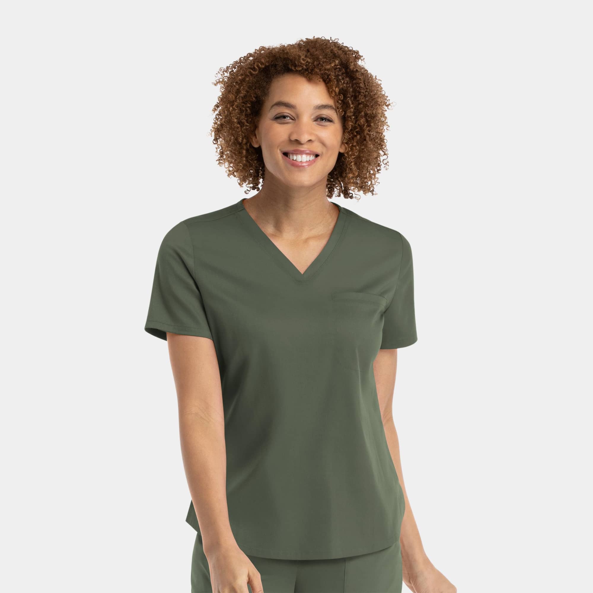 A green women's v-neck top with a tuckable design, featuring short sleeves and a relaxed fit. Matrix Womens Tuckable V-Neck Top - Image 1