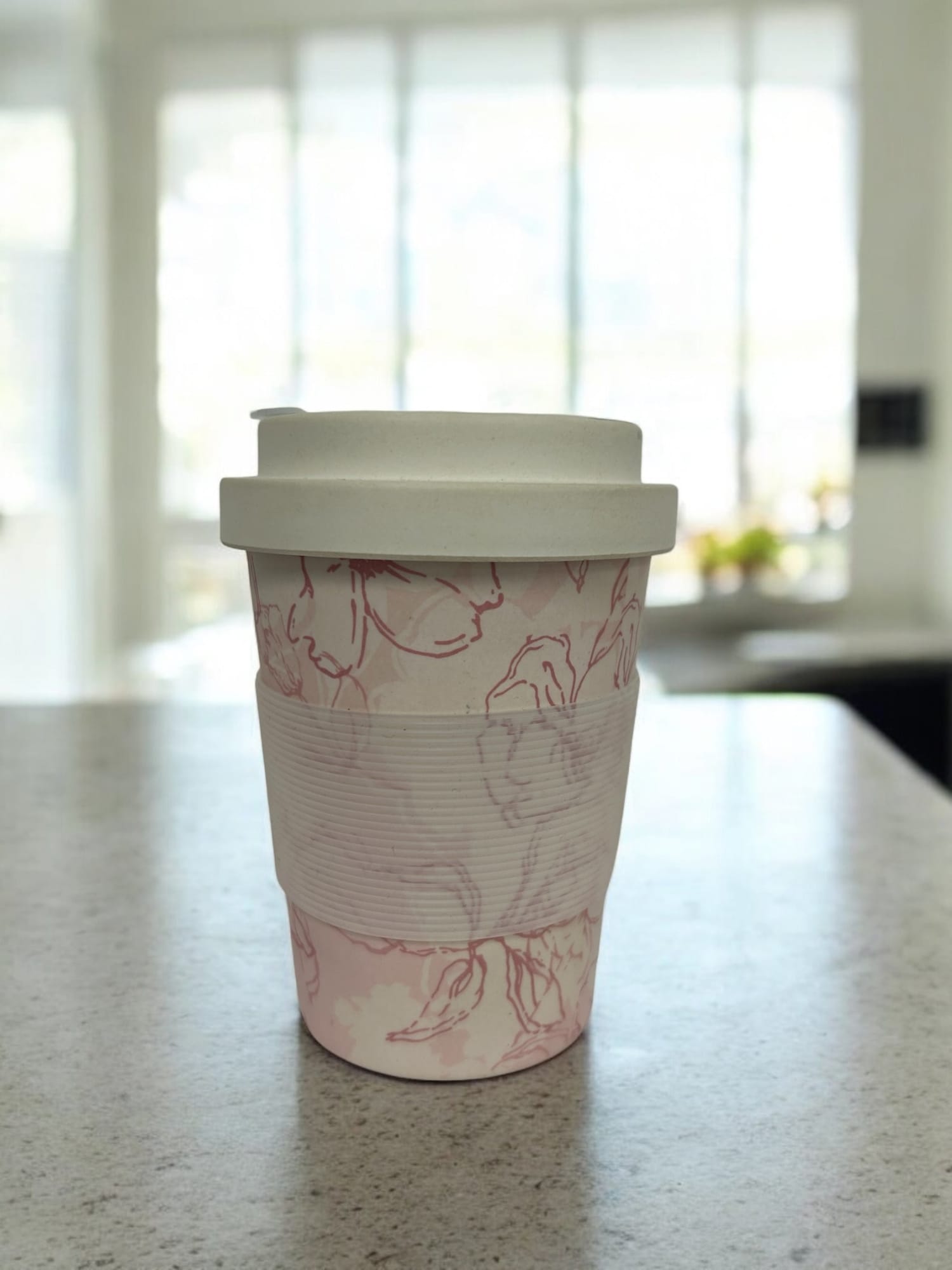 A reusable bamboo coffee cup with a hard lid, featuring a floral design in pink and white. 350ml Bamboo Coffee Cups (Hard Lid) - Image 1