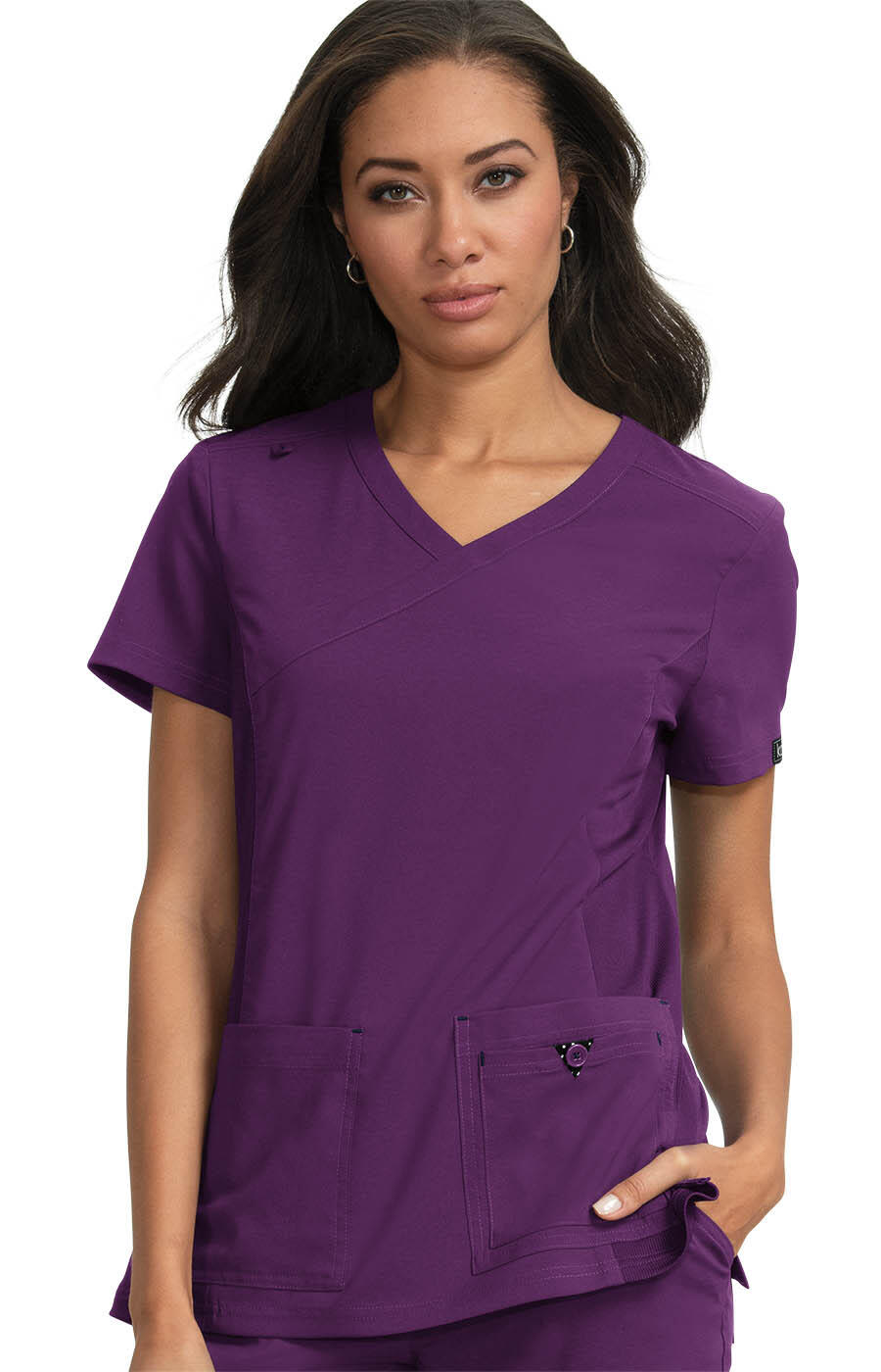 A purple medical scrubs top with a V-neck design and front pockets, featuring a logo on the side. Katie Top - Image 1