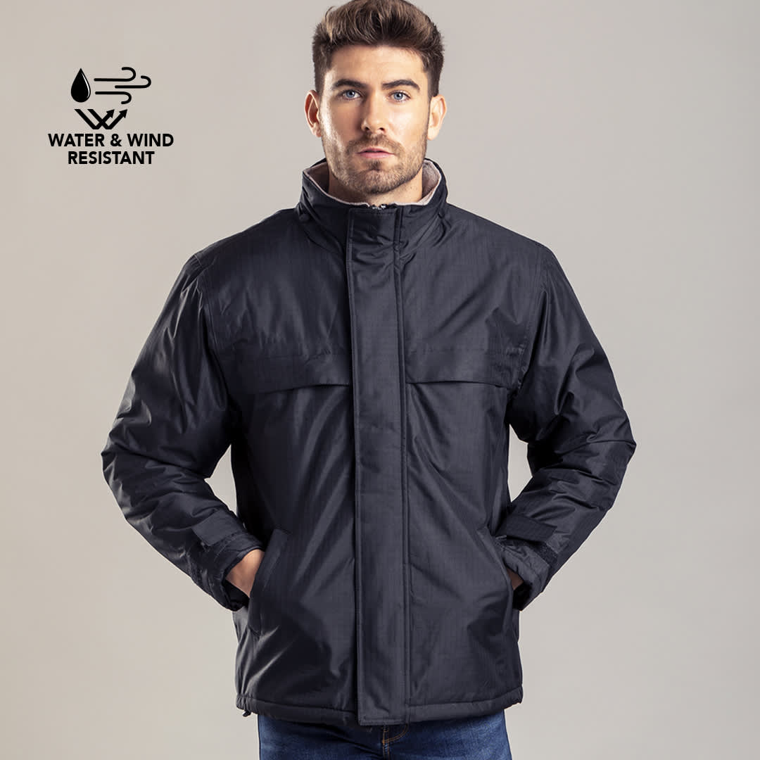 A dark blue rain jacket with a collar and pockets, featuring a logo indicating water and wind resistance. Zylka Parka - Image 1