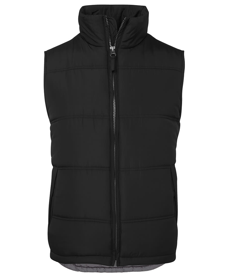 A black puffer vest with a high collar and zip closure, featuring padded sections and an internal lining. JB's Adv Puffer Vest - Image 1
