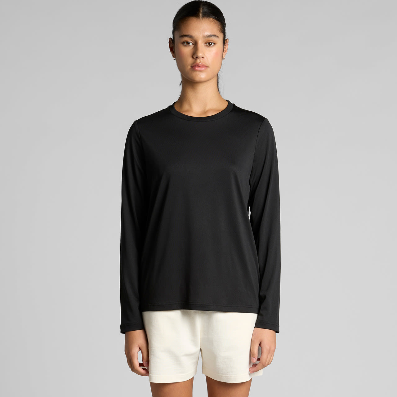 A black long-sleeve tee with a round neckline, featuring a logo on the front and a relaxed fit. Wo's Maple Active L/S Tee - Image 1