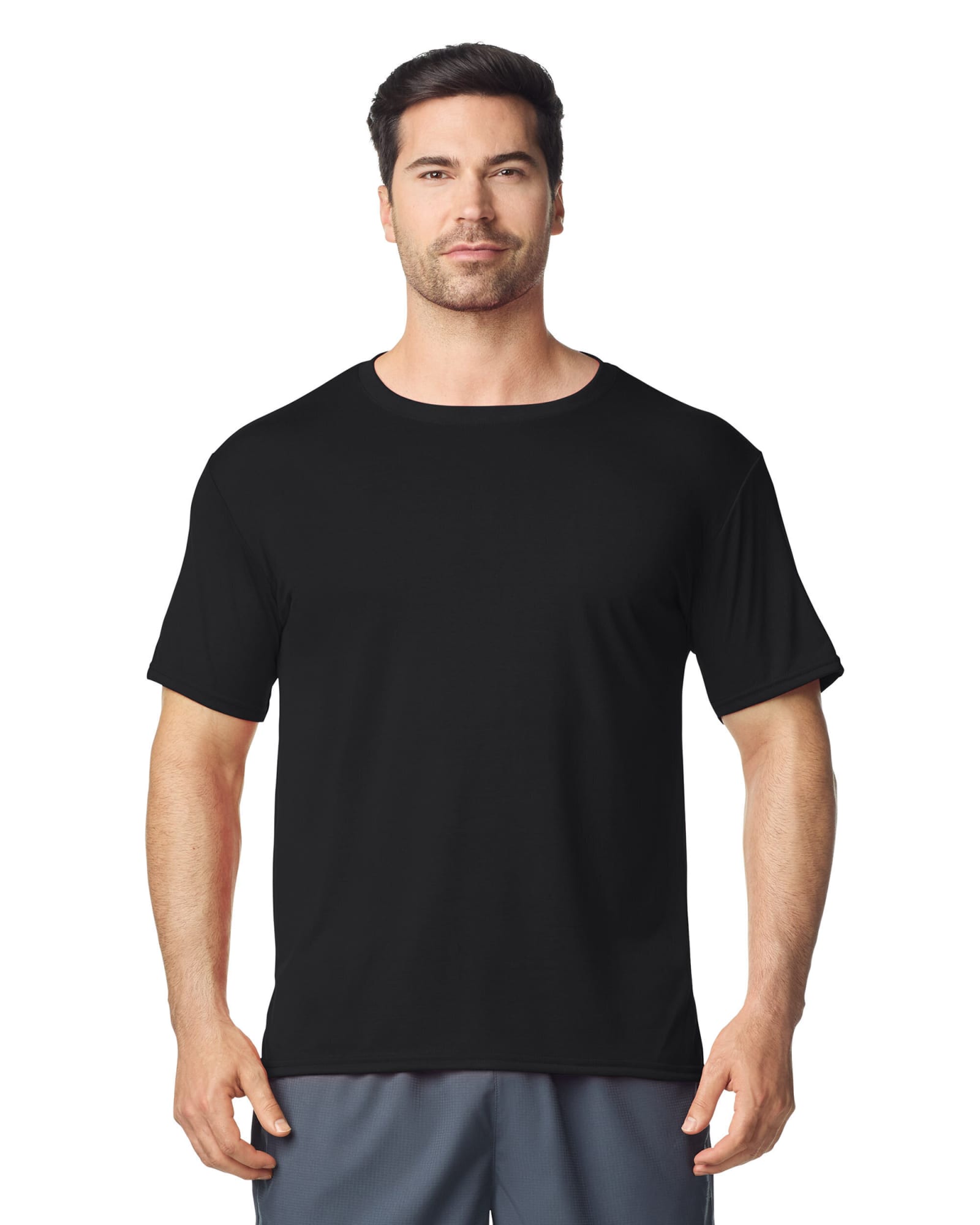 A black Gildan Performance adult T-shirt on a male model, featuring short sleeves and a round neckline. Gildan Performance Adult T-Shirt - Image 1
