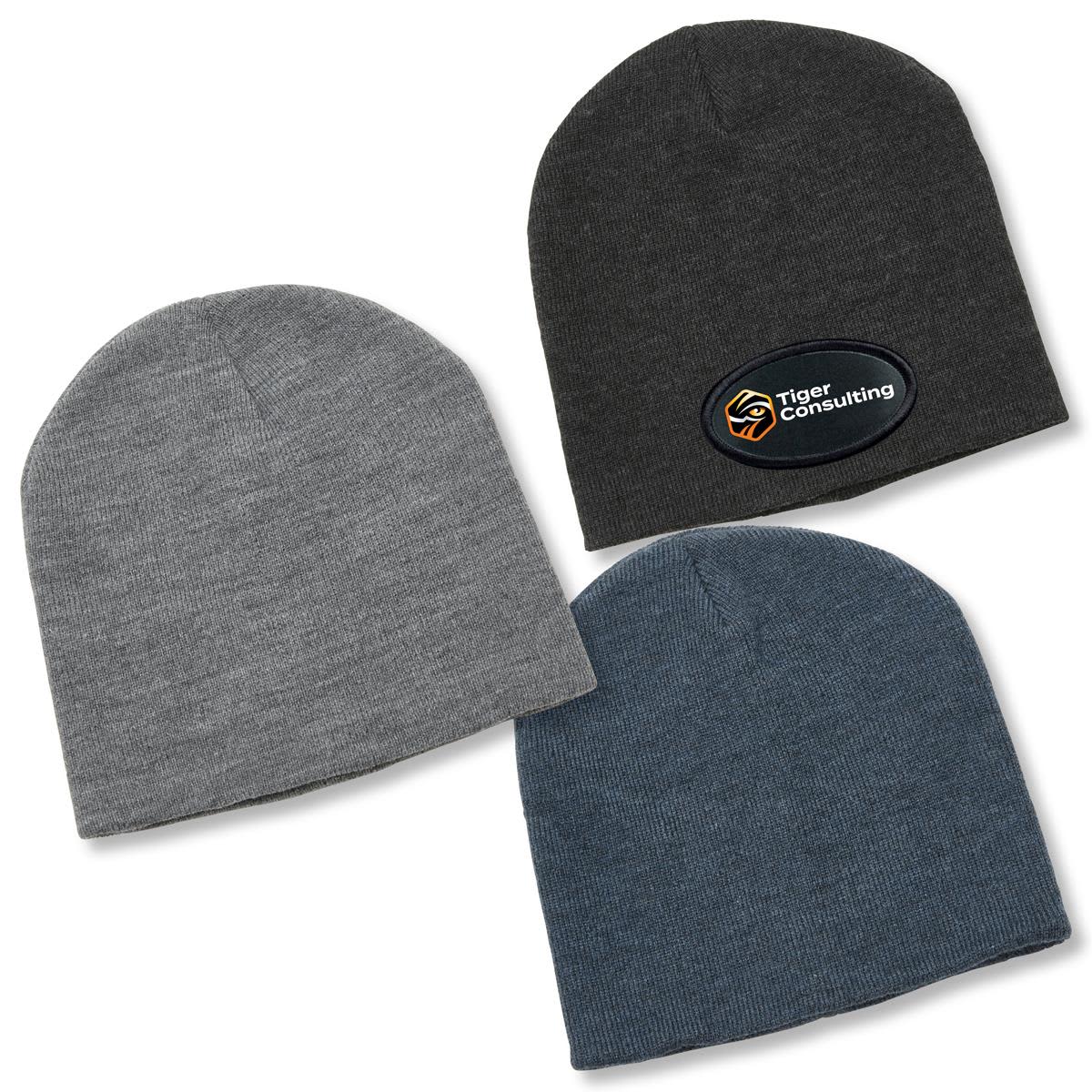 A collection of three beanies in grey, dark grey, and blue, featuring a logo on one hat. Heather Skull Beanie - Image 1