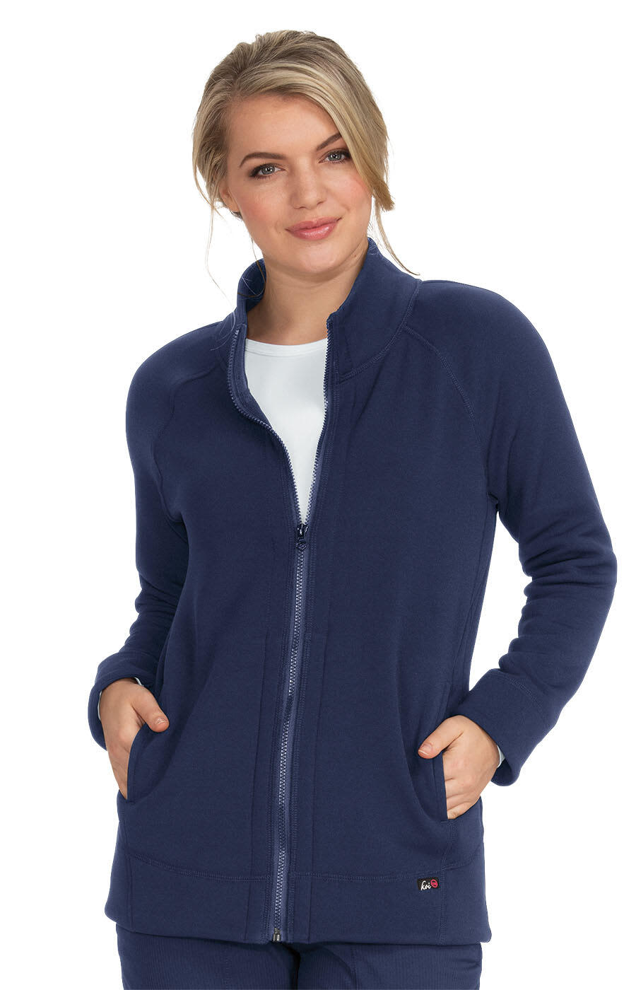 A navy blue wellness jacket with a zip front and pockets, worn by a woman standing confidently. Wellness Jacket - Image 1