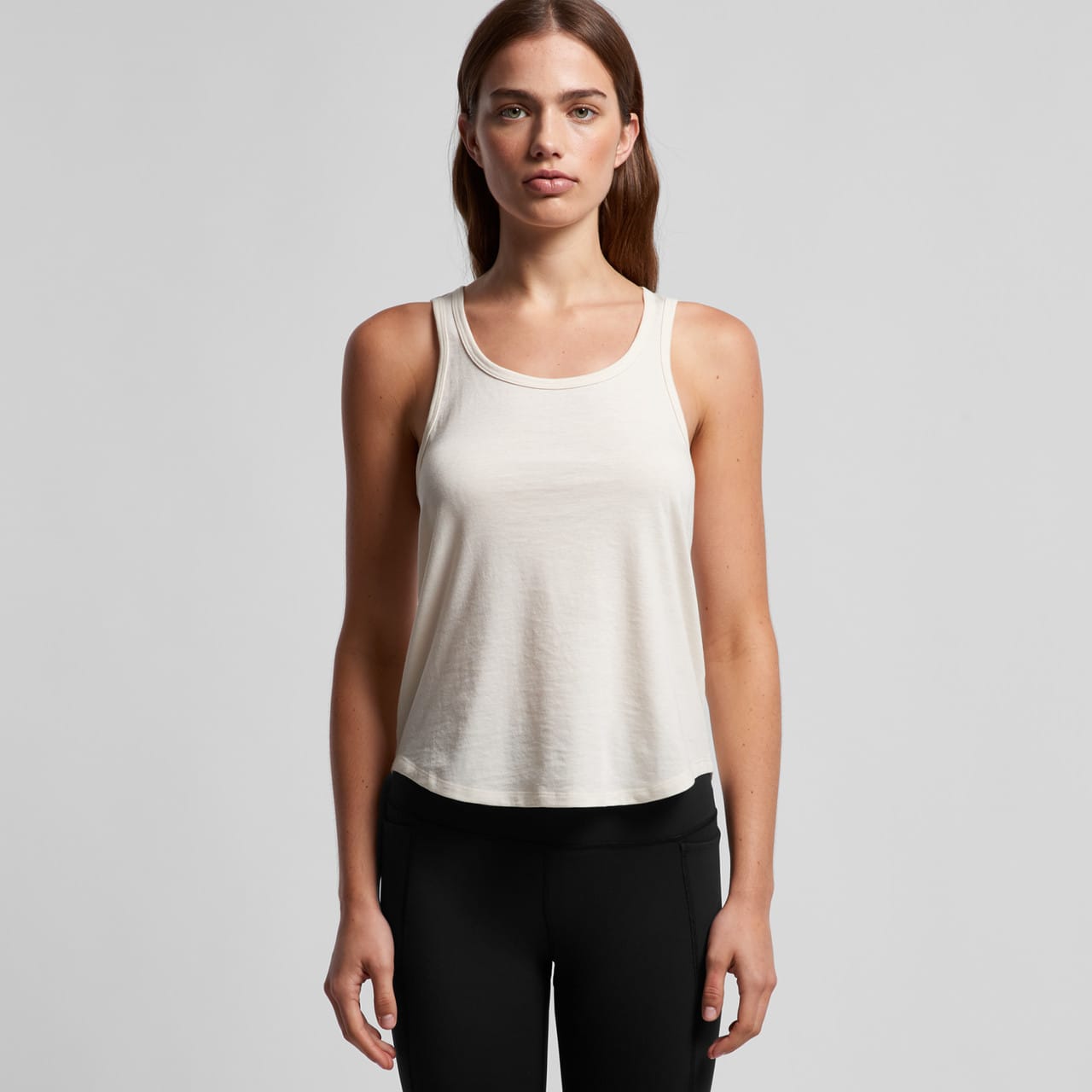 A light cream racerback singlet featuring a relaxed fit, with a logo on the front. Wo's Maple Active Blend Racerback - Image 1