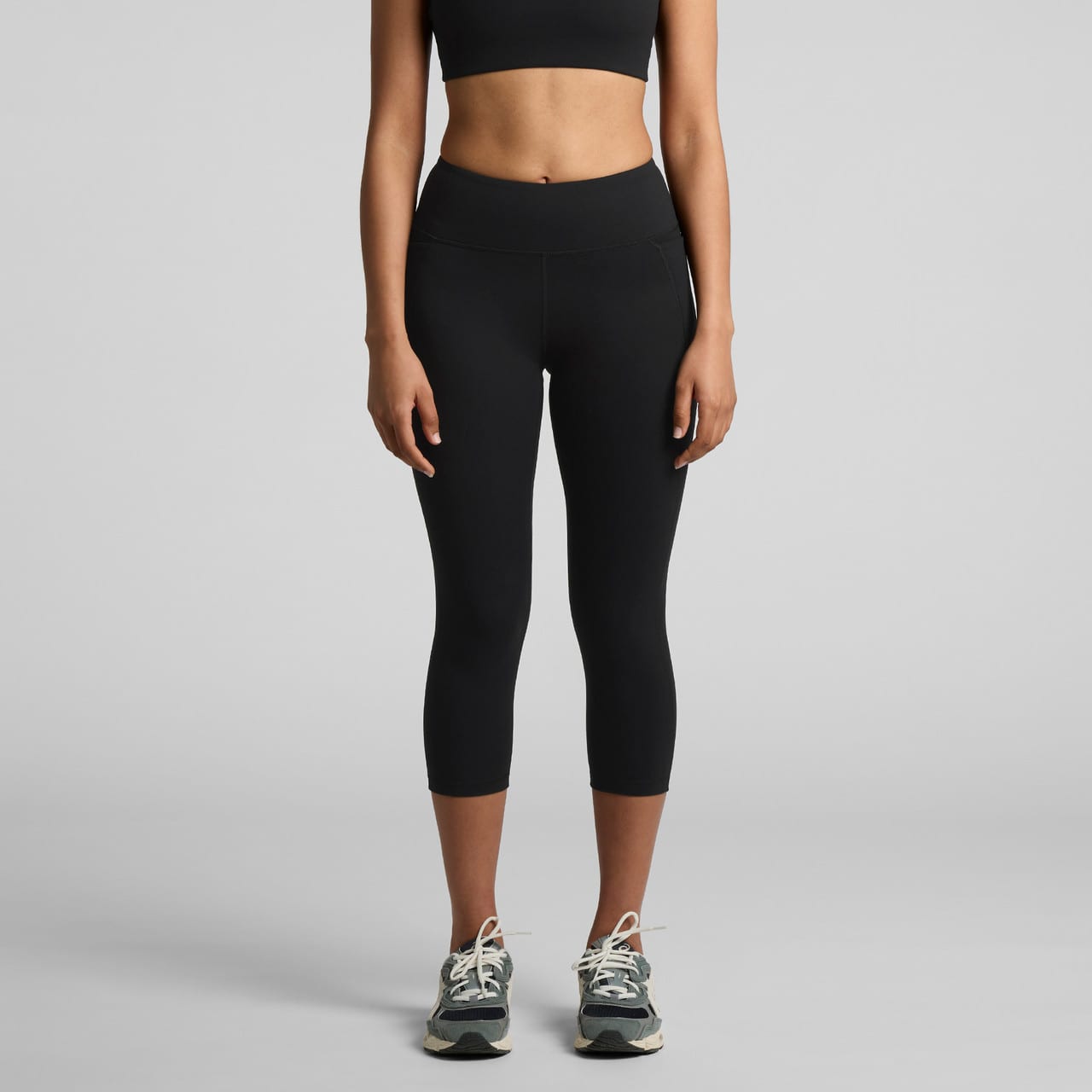 Active mid leggings in black, featuring a high waistband and cropped length, paired with athletic shoes. Wo's Active Mid Leggings - Image 1