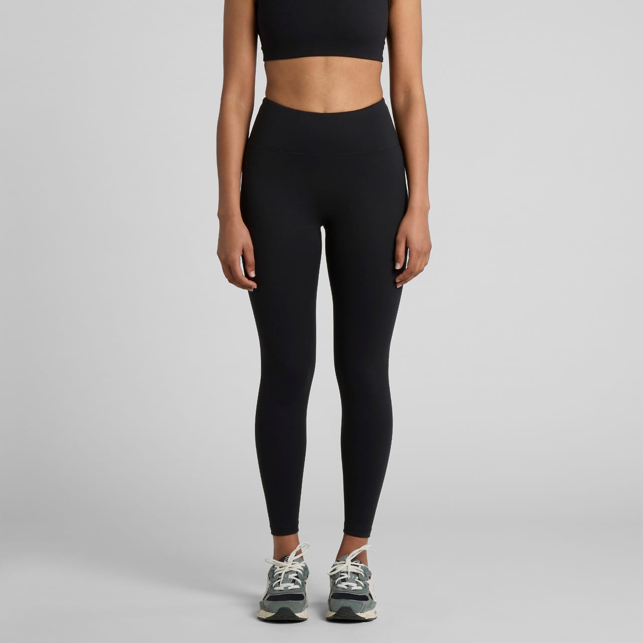 Active seamless leggings in black, styled with a matching crop top and trainers. The product features a logo. Wo's Active Seamless Leggings - Image 1