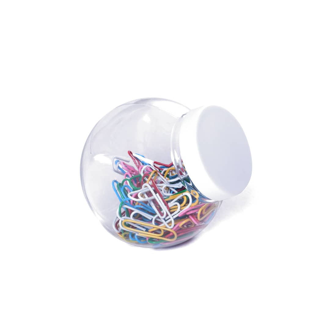 A clear jar with a white lid filled with colourful paper clips in various shades. Rhydor Clips Holder - Image 1