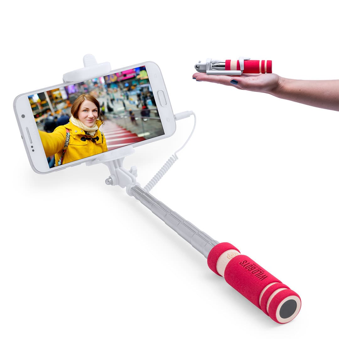 A selfie stick with a red and white grip, extending to hold a smartphone, featuring a logo on the handle. Paicom Selfie Stick - Image 1