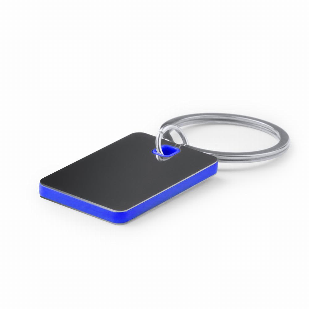 A keyring featuring a rectangular tag with a silver surface and a blue edge. The keyring has a circular attachment. Persal - Image 1