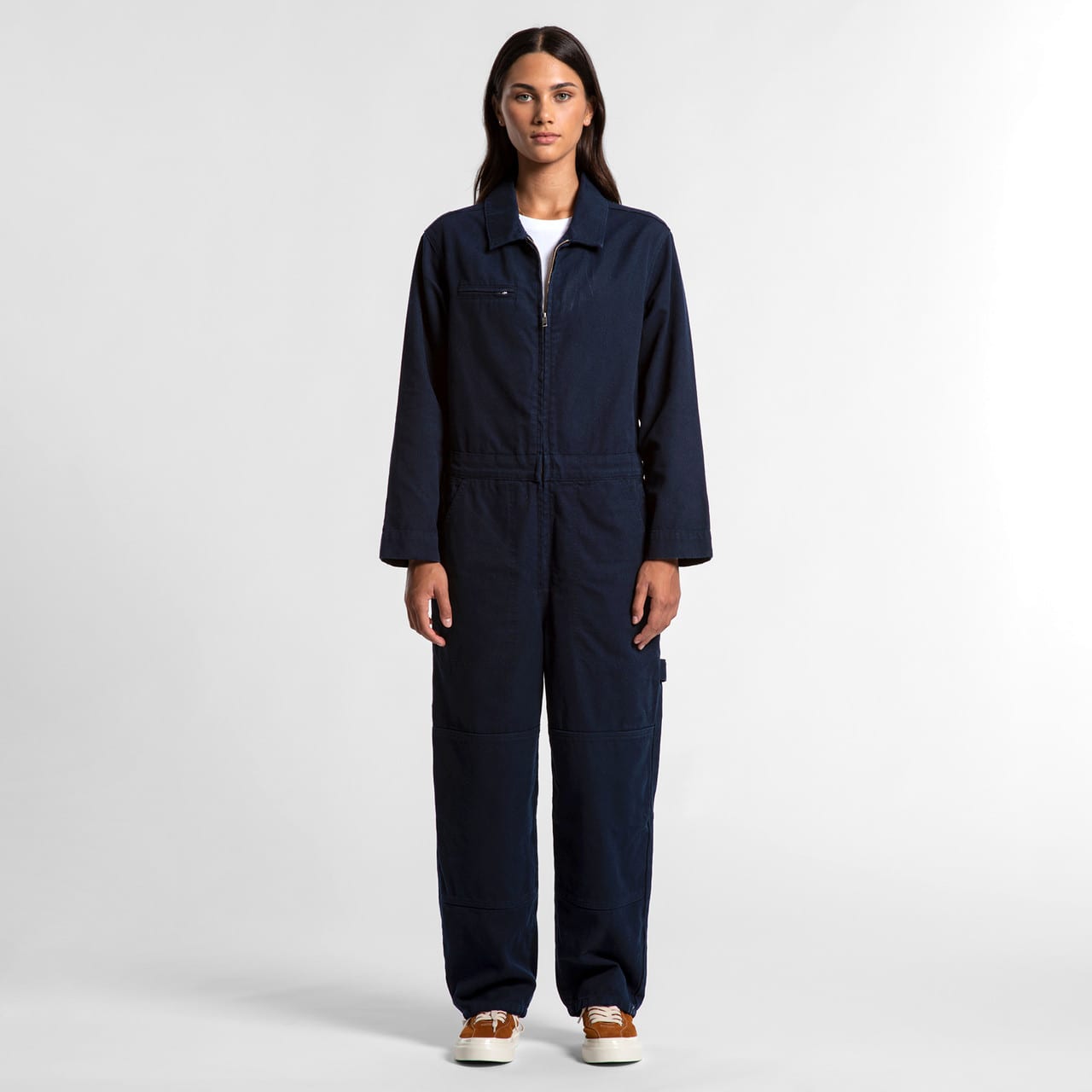 A navy blue coverall with a zip front and pockets, featuring sleeves and a relaxed fit. It has a branding logo. Wo's Canvas Coveralls - Image 1