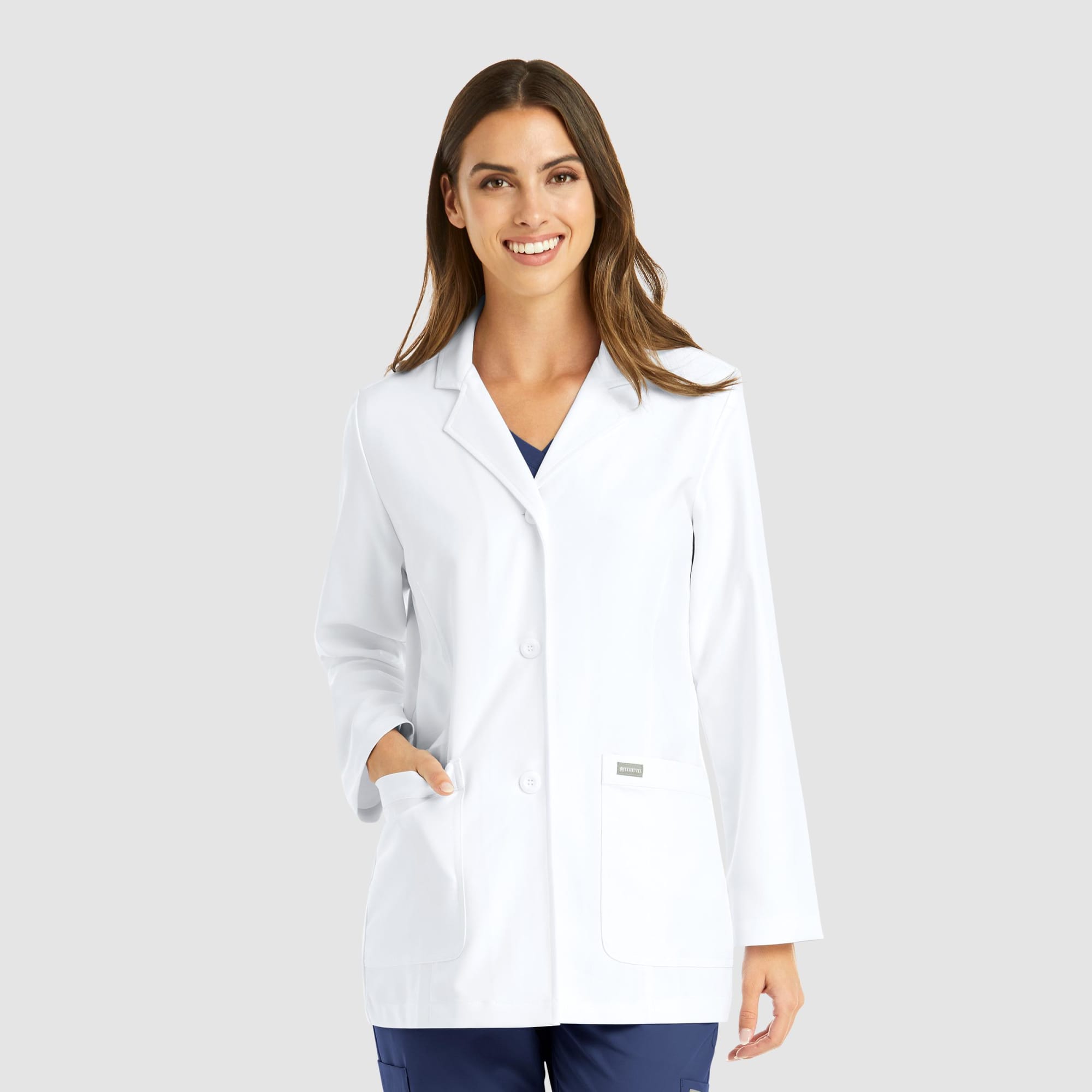 A white women's lab coat featuring a classic design, with long sleeves, buttons, and a pocket. Includes branding. Momentum Womens Consultation Lab Coat (29") - Image 1