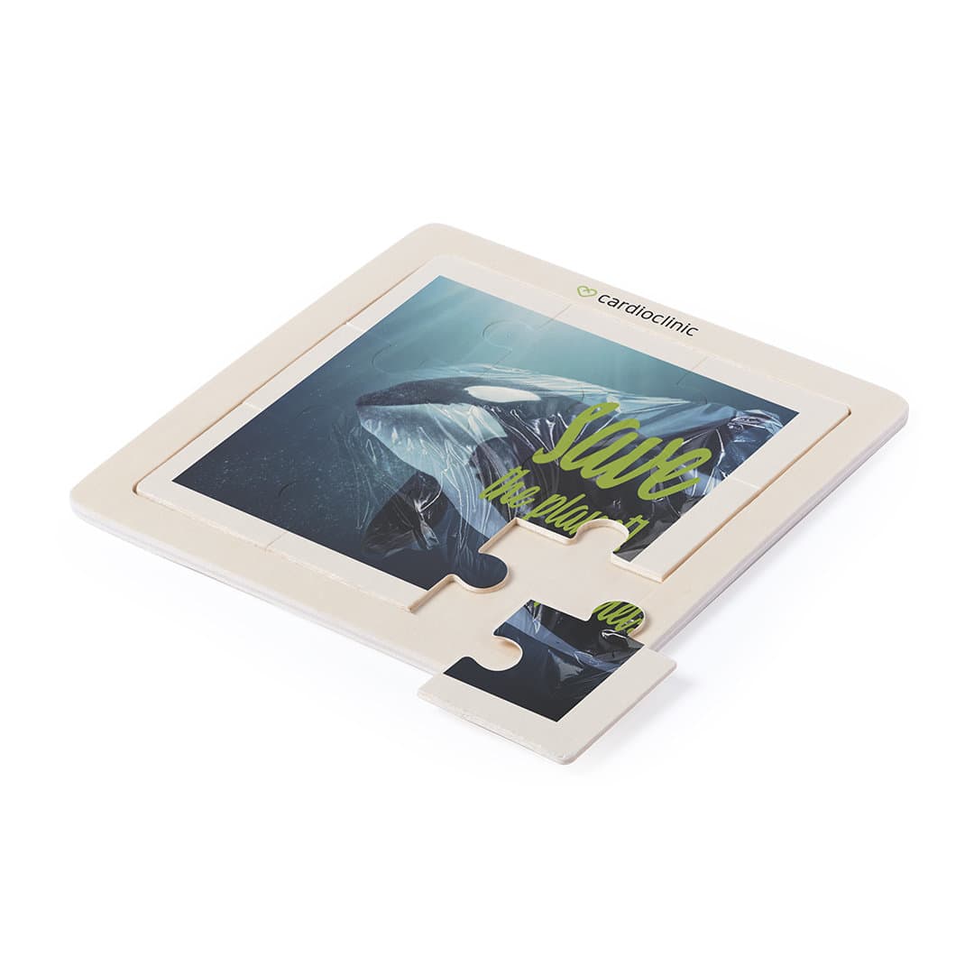 A wooden puzzle featuring an ocean scene with a whale. The puzzle has a logo and is primarily in natural wood tones. Sutrox Puzzle - Image 1