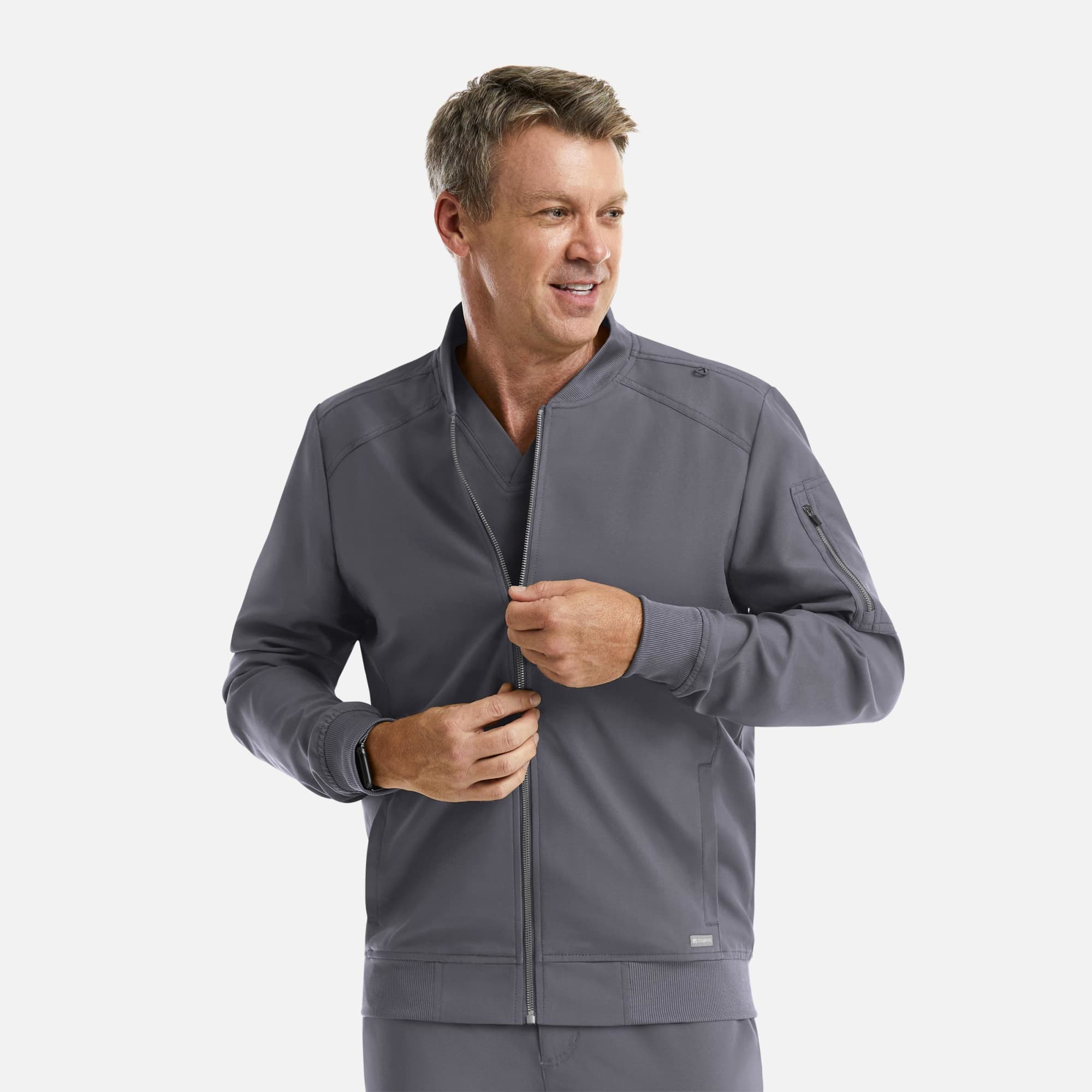 A man wearing a grey full zip bomber jacket, featuring zip pockets and a fitted design. Momentum Mens Full Zip Bomber Jacket - Image 1