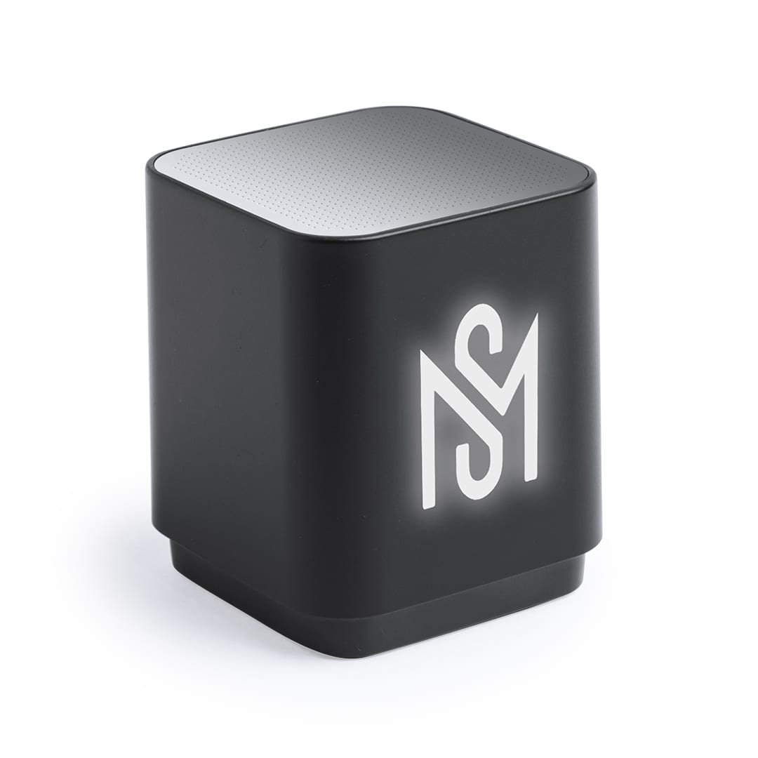 A compact black speaker with a silver top and a logo on the front, featuring a sleek, modern design. Lunem Speaker - Image 1