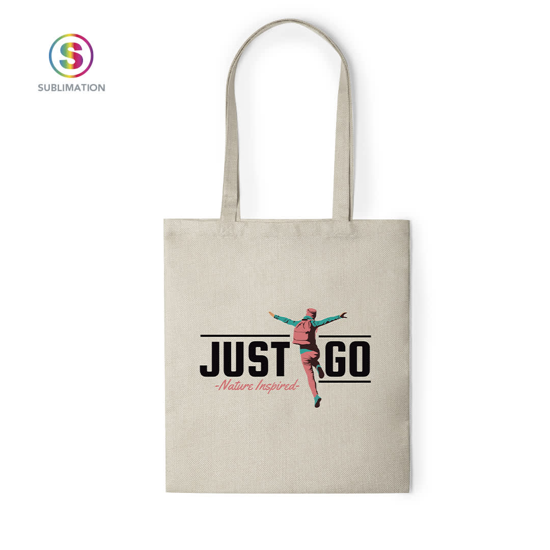 A natural beige tote bag featuring a dancer graphic and a logo. The design includes the text "JUST GO - Nature Inspired." Prosum Sublimation Bag - Image 1