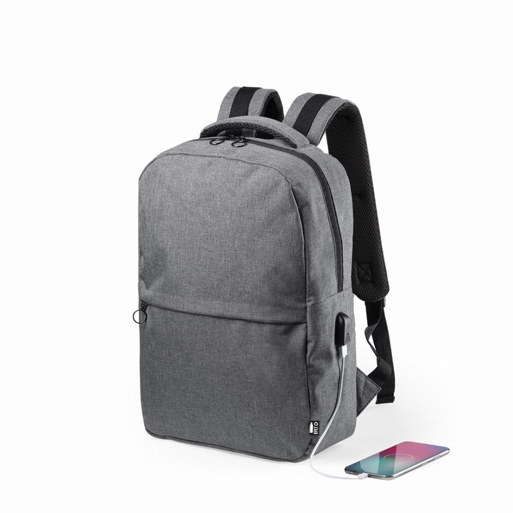 A grey backpack with a front pocket and USB charging port, featuring padded shoulder straps. Konor - Image 1