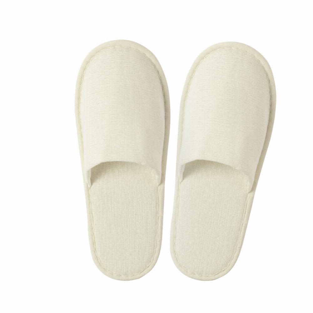 A pair of cream-coloured spa slippers with open toes and soft fabric. They have a simple, elegant design. Nalton - Image 1