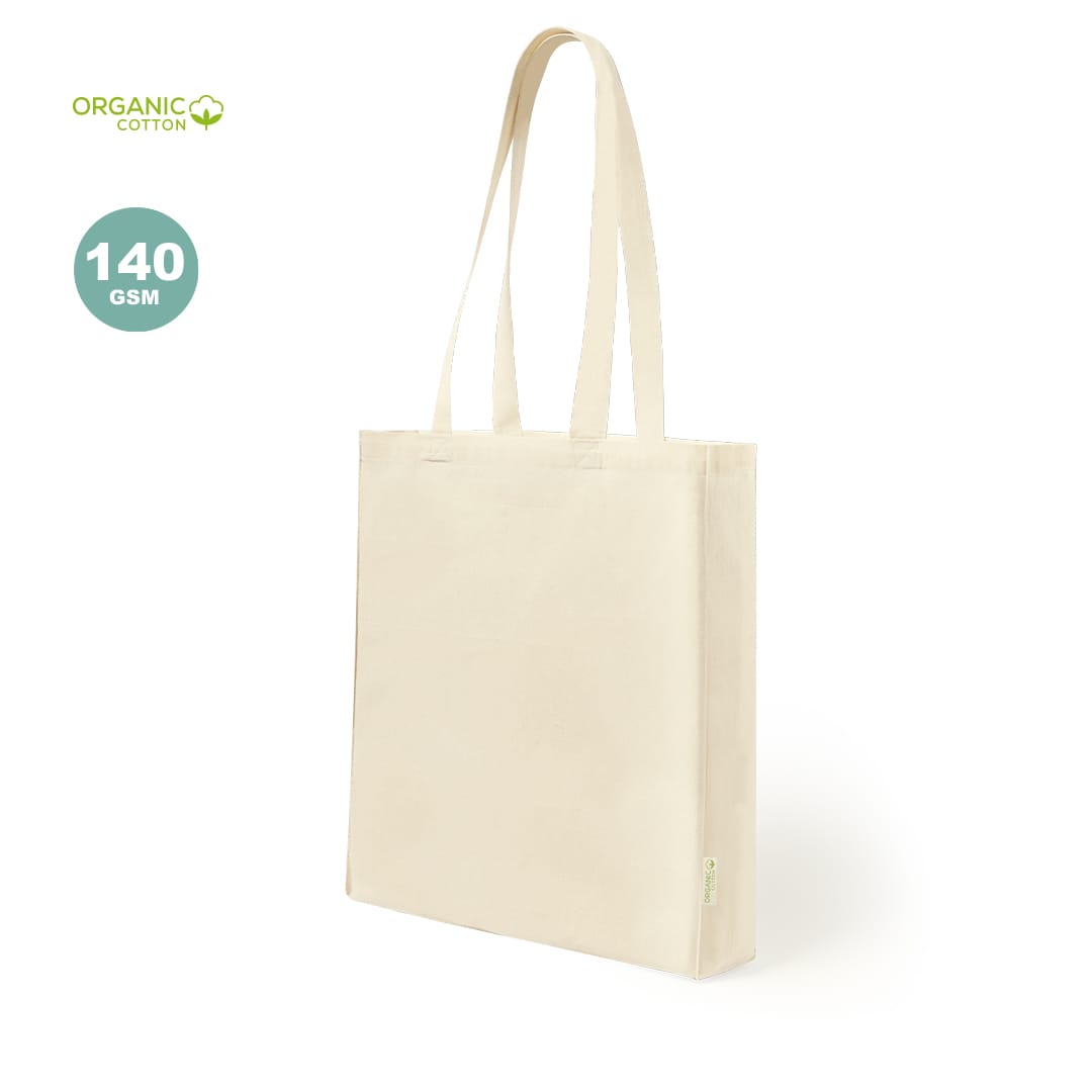 A beige tote bag made from organic cotton, featuring two long handles and a logo. Casim Bag - Image 1