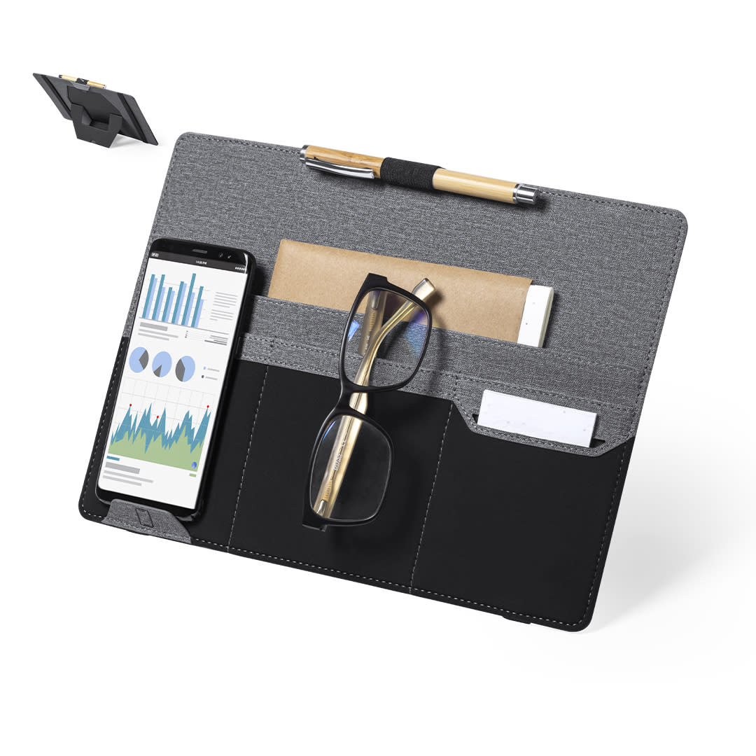 A grey and black organiser with compartments for a phone, glasses, a pen, and a notepad, featuring a stand and branding. Tronser Holder Organizer - Image 1