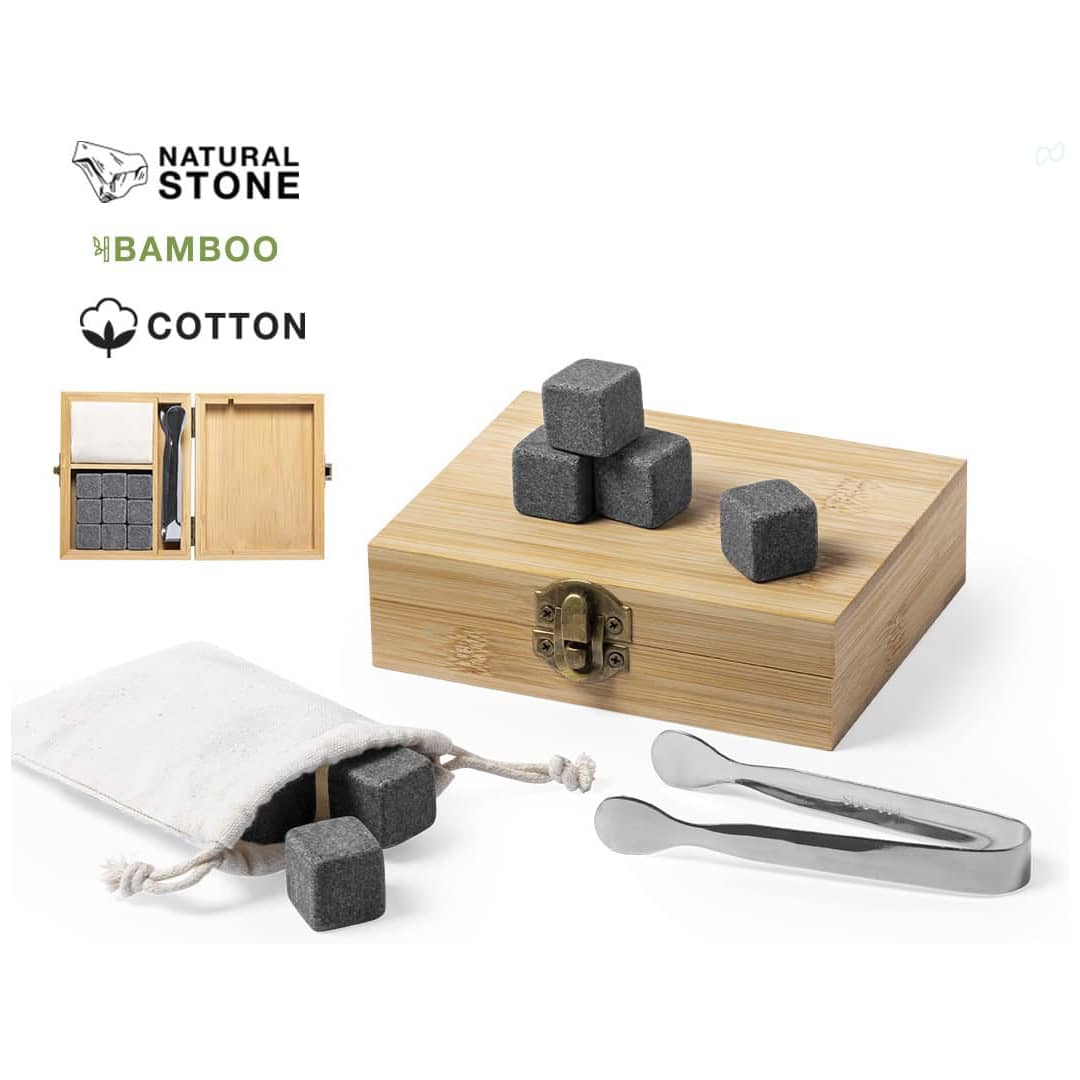 A bamboo box containing natural stone ice cubes, with a cotton pouch and stainless steel tongs. The ice cubes are grey. Holier Set Stone Ice Cubes - Image 1