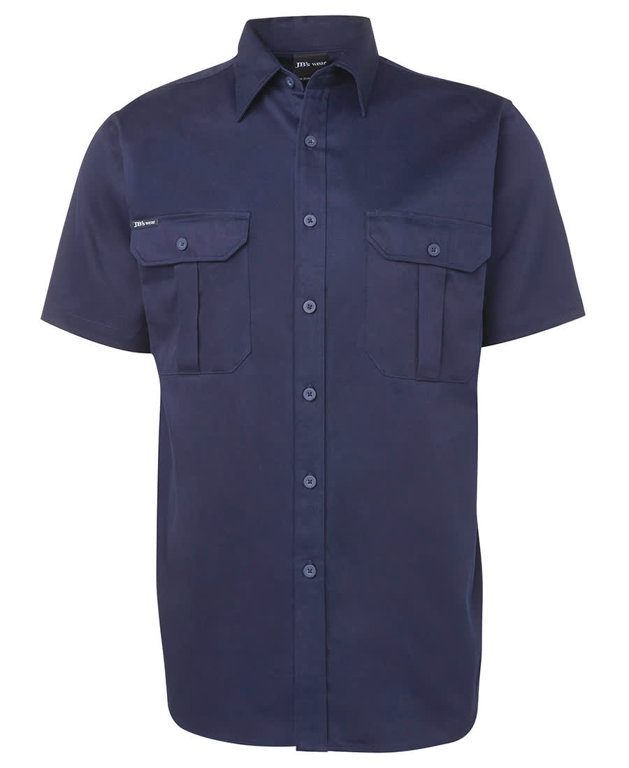 Short-sleeved navy work shirt with two front pockets and button closure. Features a logo on the label. JB's S/S 190 G Work Shirt Navy - Image 1