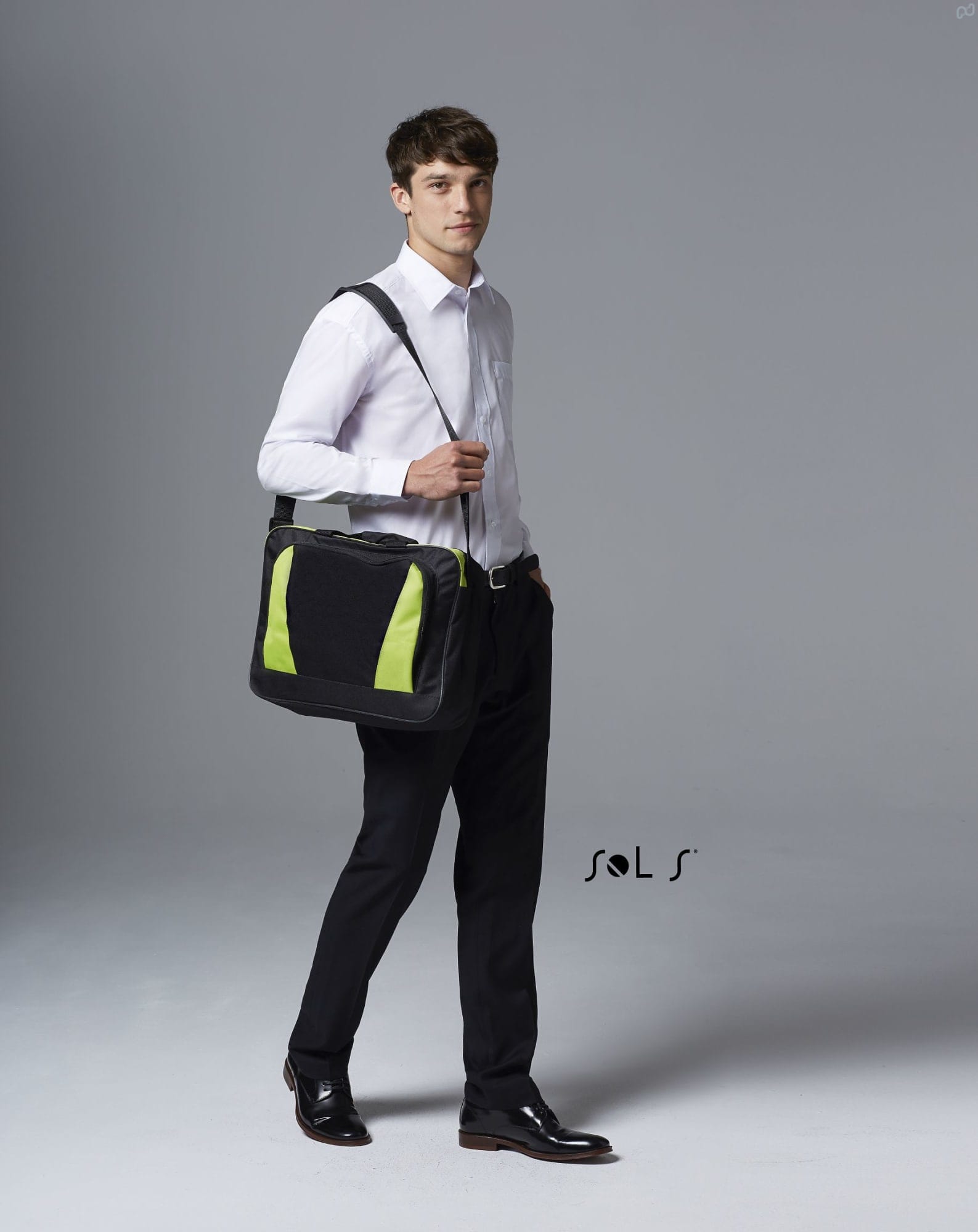 A black briefcase with green accents is held by a man in formal attire, standing against a neutral background. CAMBRIDGE 600D POLYESTER BRIEFCASE - Image 1