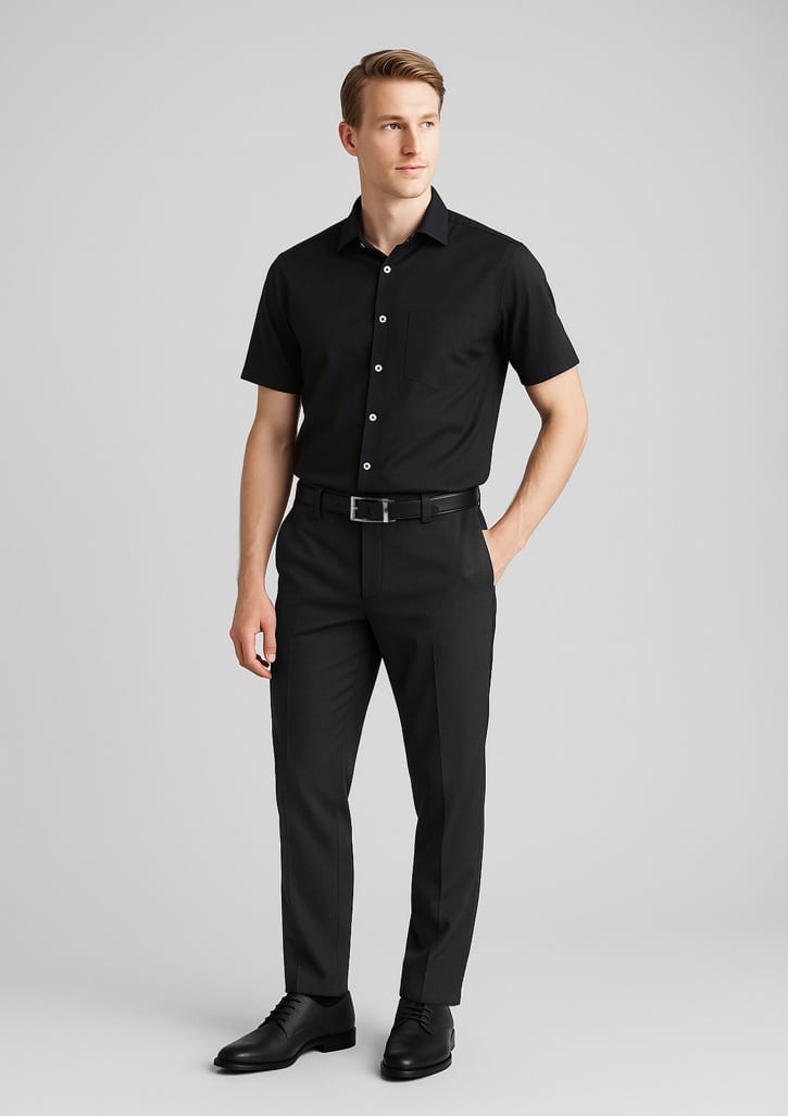 A pair of black slimline pants made of wool stretch, modelled by a man in a black short-sleeve shirt and belt. Mens Comfort Wool Stretch Slimline Pant - Image 1