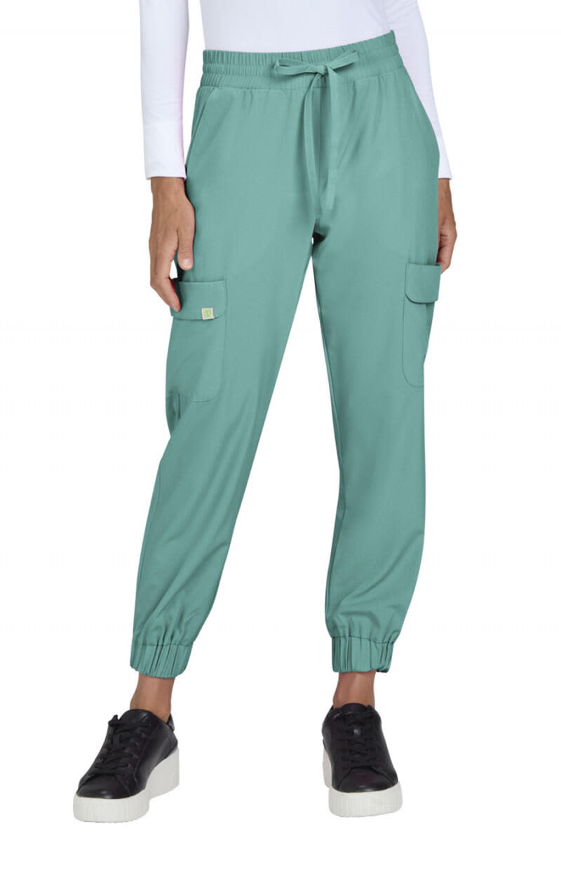 A pair of teal jogger pants featuring cargo pockets and elastic cuffs, worn with black shoes. The model is indoors. Terra Jogger - Image 1