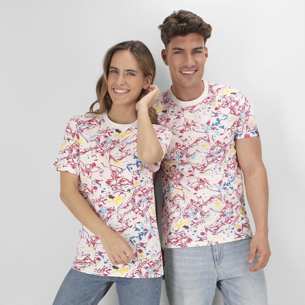 A couple models matching colourful patterned t-shirts featuring splashes of red, blue, yellow, and white. Helixa - Image 1