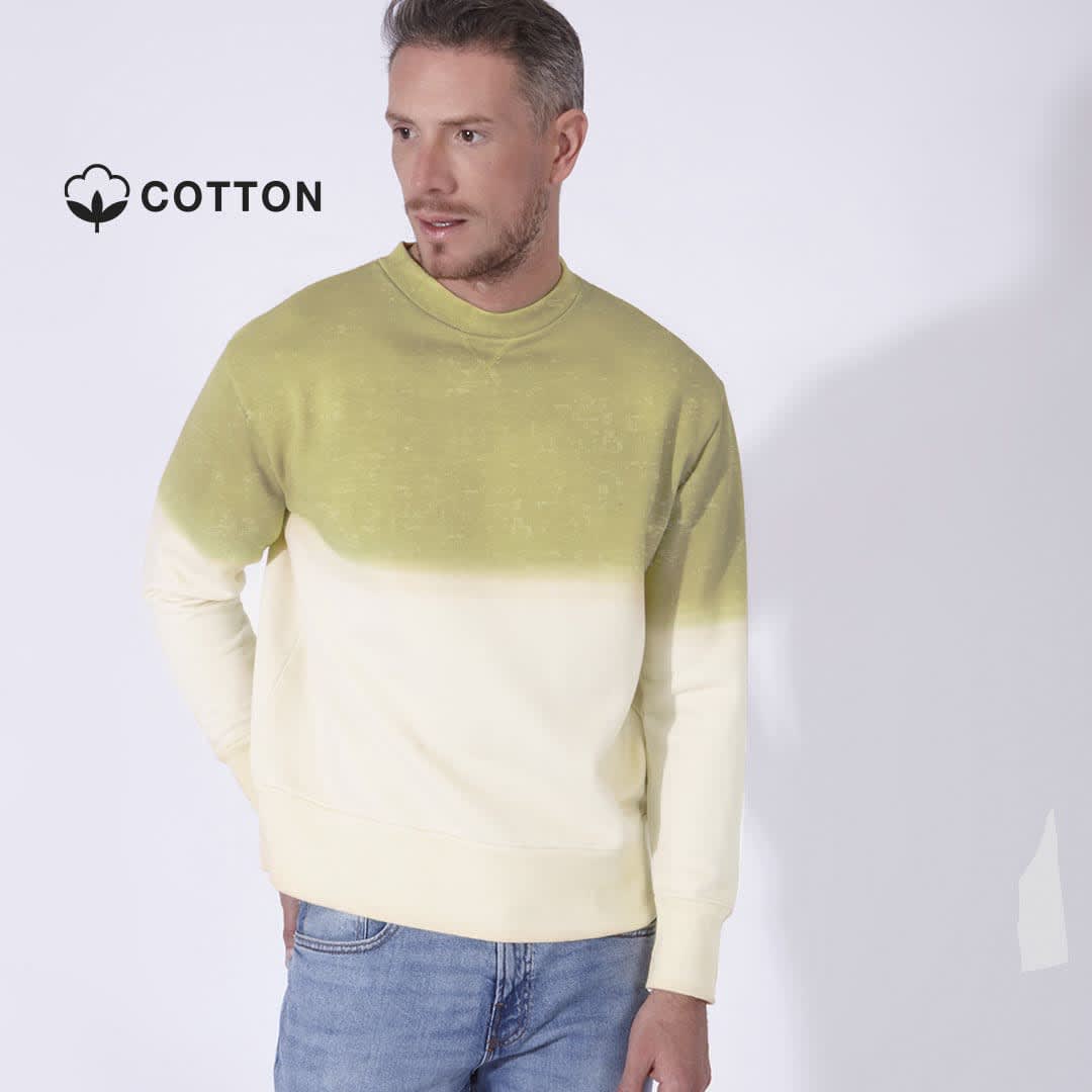 A sweater with a gradient design, featuring light yellow and green hues, worn by a man. The fabric is cotton. Truyi - Image 1