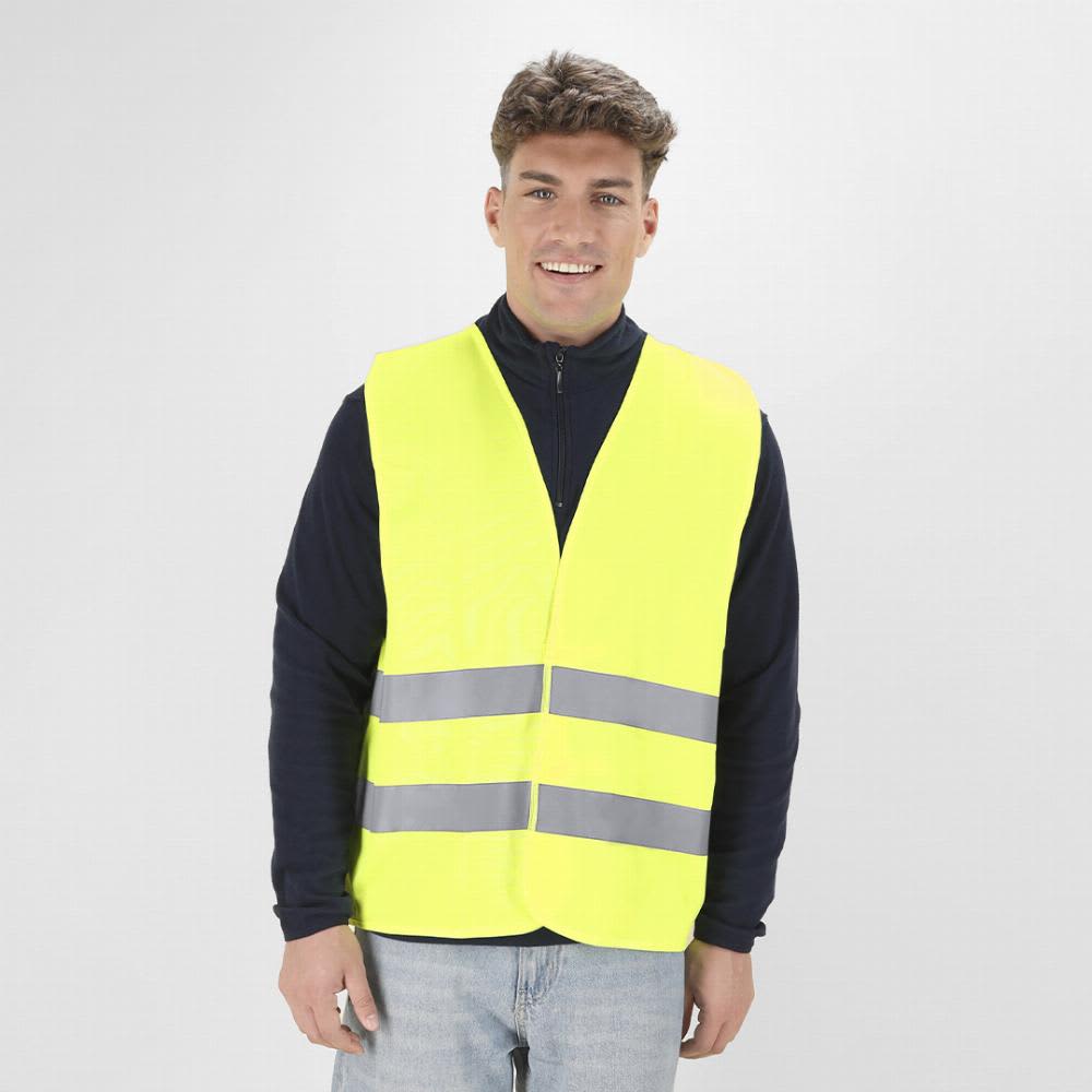 A safety vest in bright yellow with reflective grey stripes, worn by a smiling person. The background is plain. Kross - Image 1