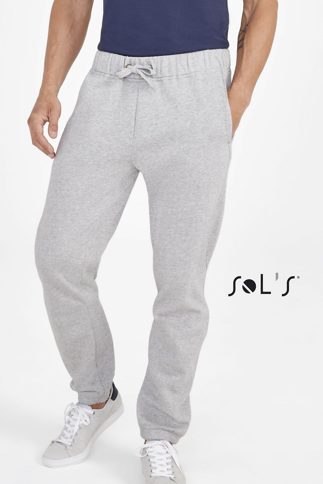 Grey jogger pants made of 50% cotton and 50% polyester, featuring an elastic waistband and a logo. Track suit pants 50% cotton 50% polyester JOGGER - Image 1