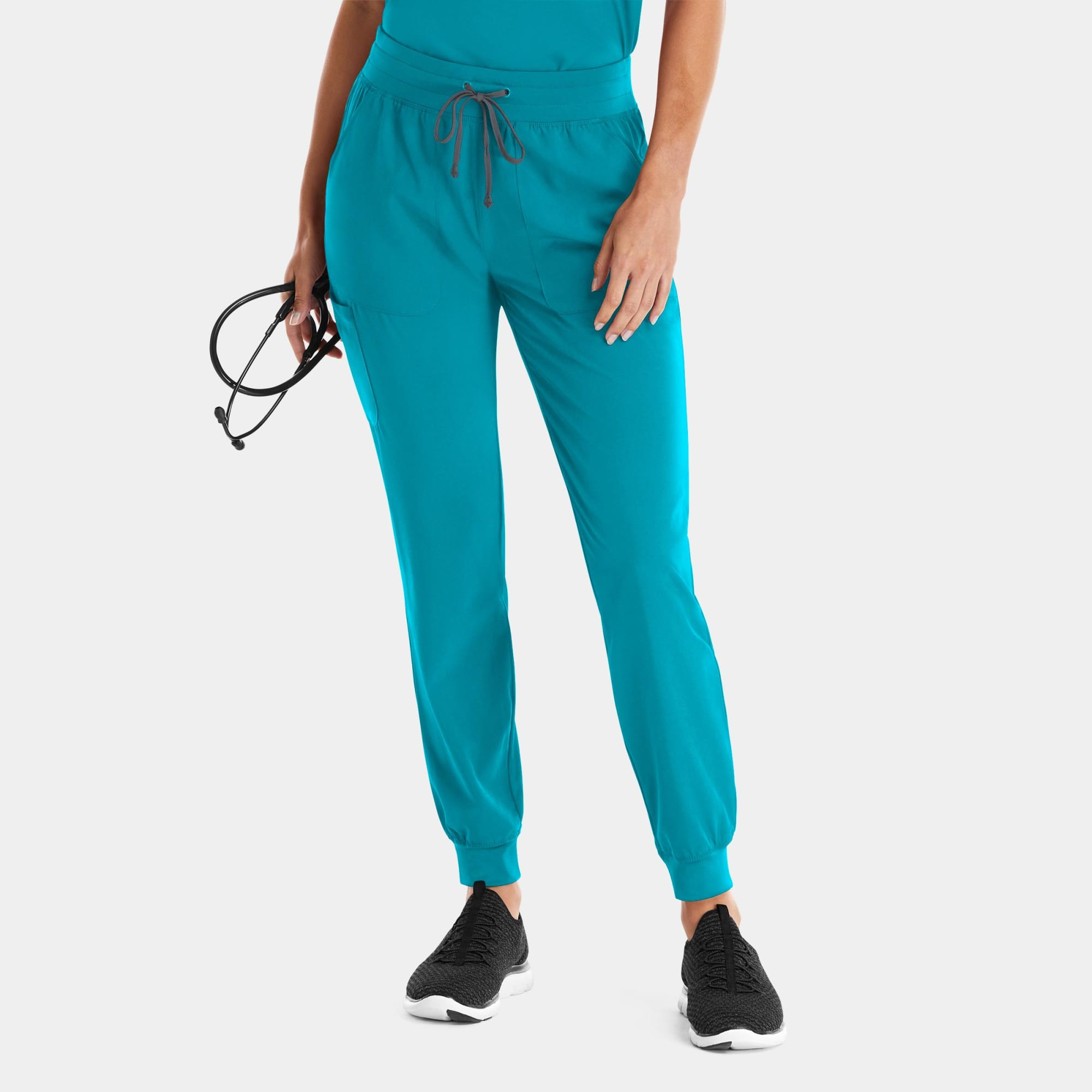 A pair of turquoise joggers with an elastic waistband, tapered fit, and drawstring detail, featuring a logo. Matrix Impulse Womens Yoga Waist Jogger - Image 1