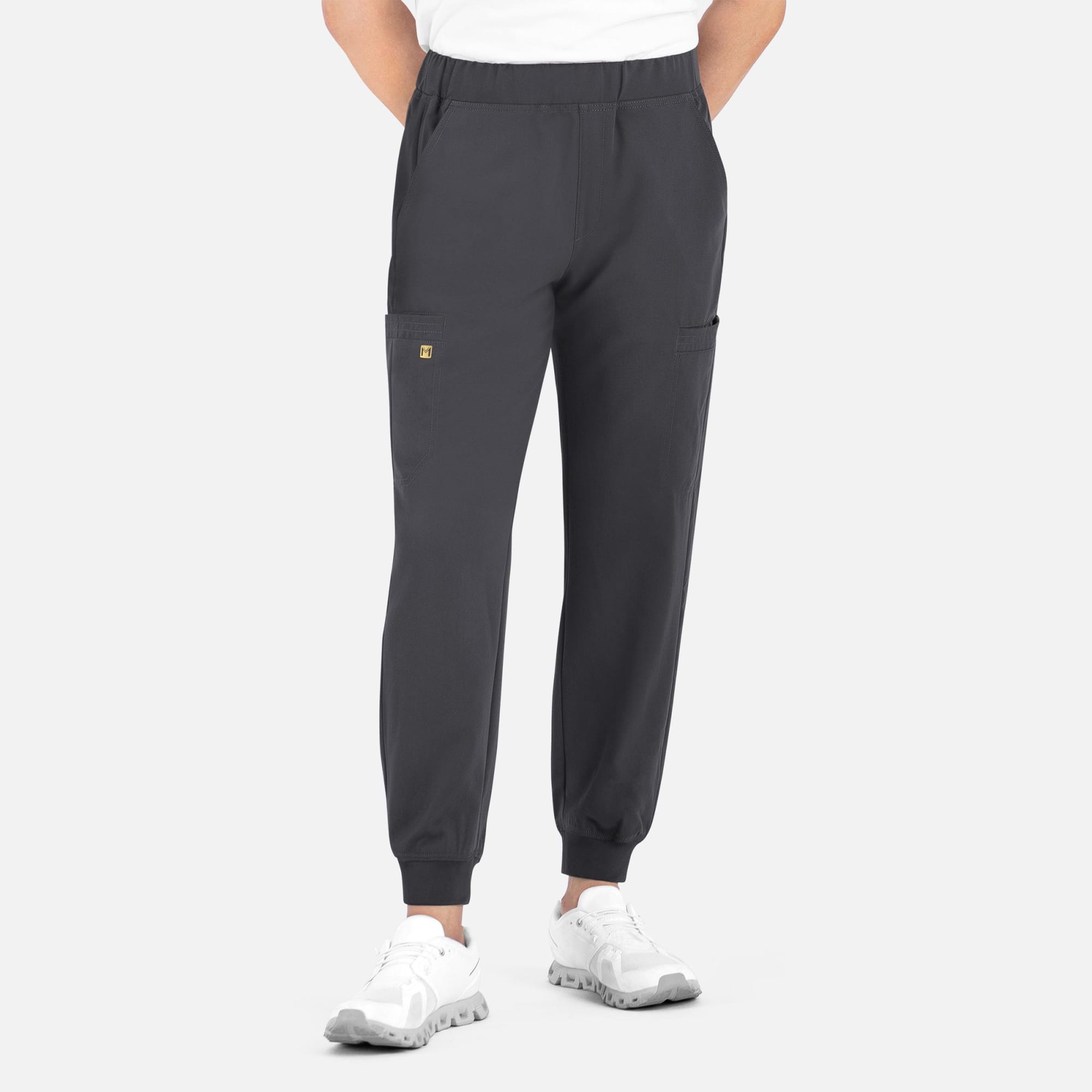A pair of men's joggers in dark grey with a full elastic waistband and side pockets. Features a logo. Matrix Pro Mens Full Elastic Waistband Jogger - Image 1