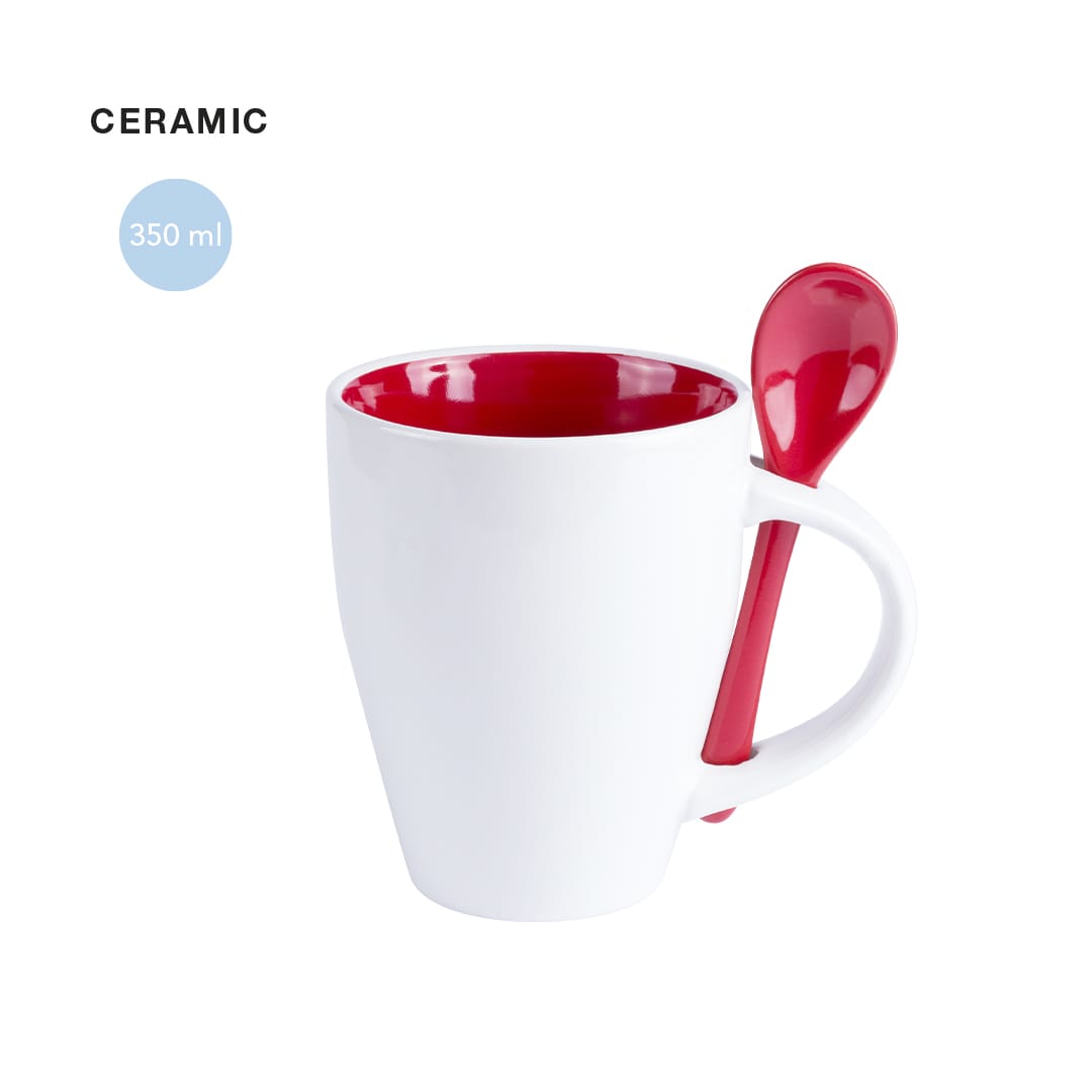 A ceramic coffee mug with a white exterior and red interior, featuring a matching red spoon attached. Holds 350 ml. Cotes Mug - Image 1