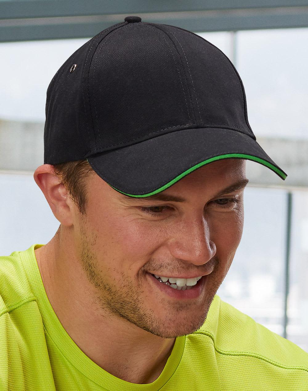 A black cap with a curved brim and red detailing, featuring a logo on the side. H/B/C sandwich peak cap - Image 1