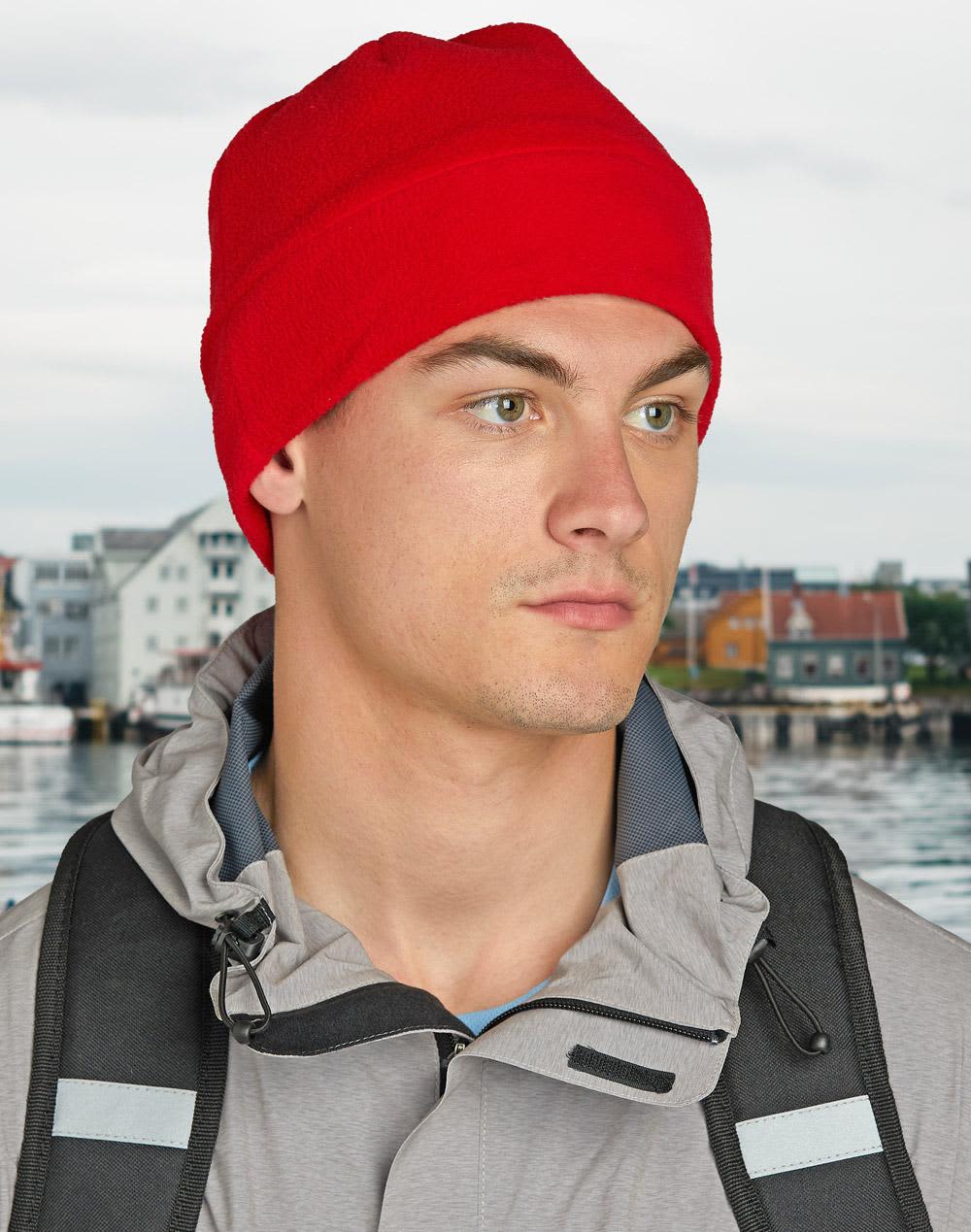 A red beanie with a soft, textured fabric and a fold-over band. It has branding on it. Polar Beanie - Image 1