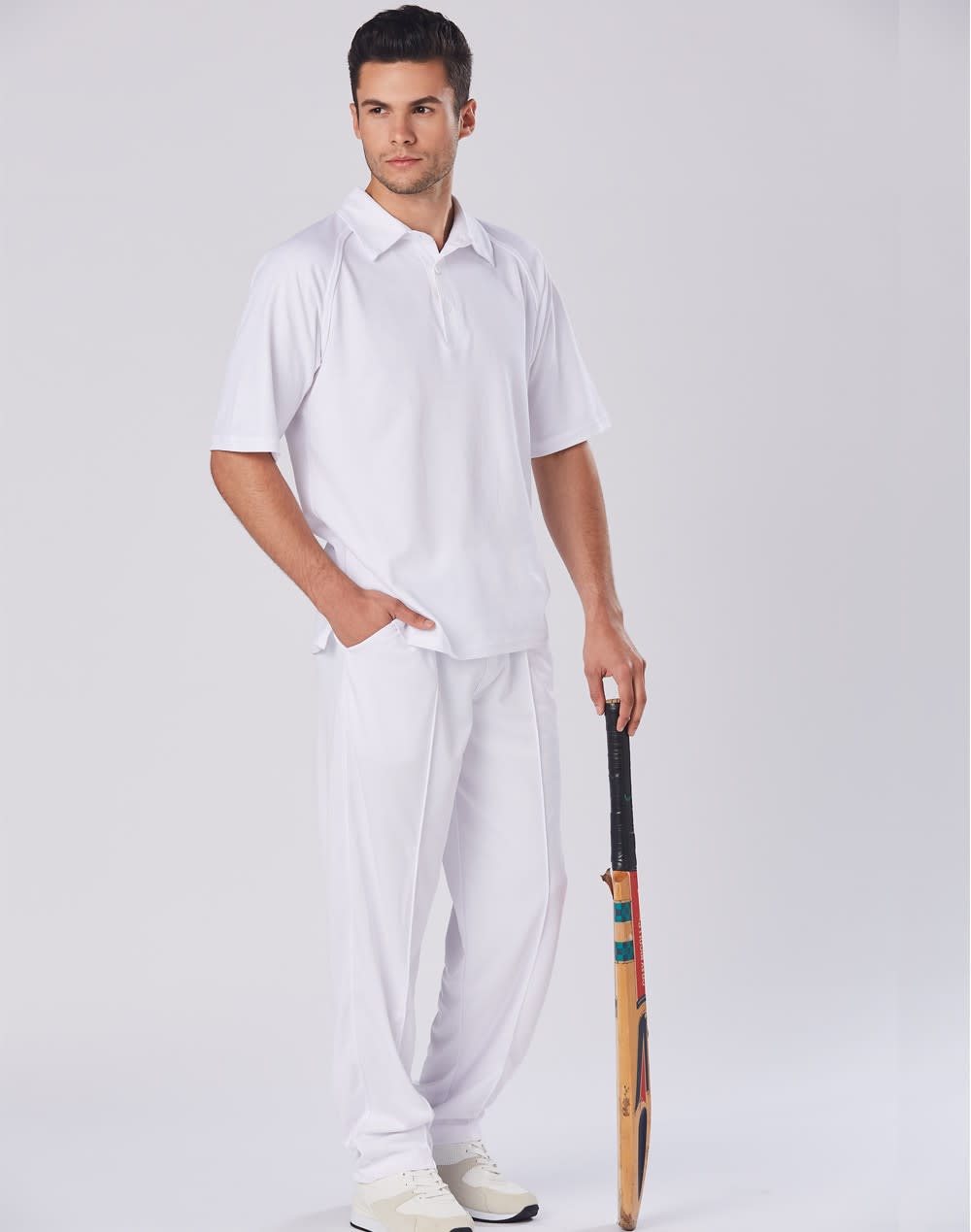 Men's cricket pants in white, paired with a matching polo shirt and holding a cricket bat. Features a logo. Mens cooldry cricket polo - Image 1